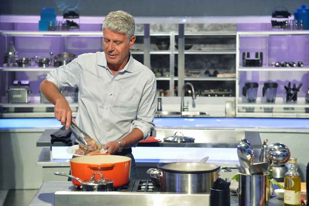 Anthony Bourdain cooking in a kitchen