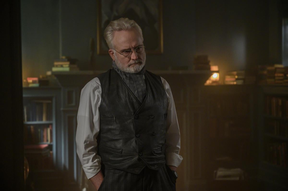 Bradley Whitford as Commander Joseph Lawrence in 'The Handmaid's Tale' Season 4 Episode 8, 'Testimony.' Bradley Whitford's character in 'The Handmaid's Tale' wasn't in Margaret Atwood's original novel, which Whitford said makes him feel 'insecure' at times. But the character is still captivating. In this photo, he stands in home library with his hands in his pockets. He wears a leather suit vest with a button-down shirt underneath and neck scarf and glasses.