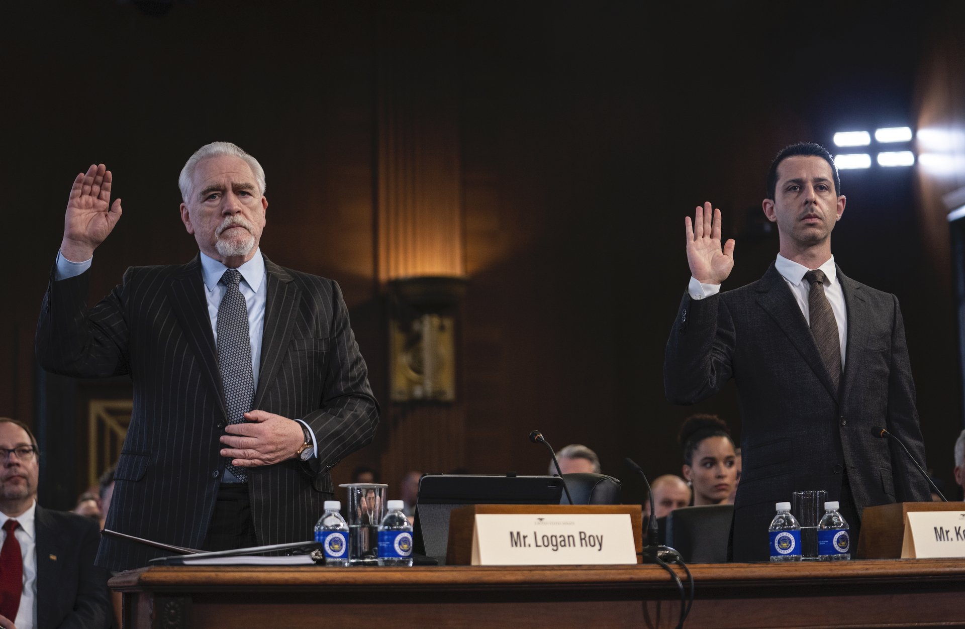 Brian Cox and Jeremy Strong raise their hands to swear in at a Congressional testimony in 'Succession.'