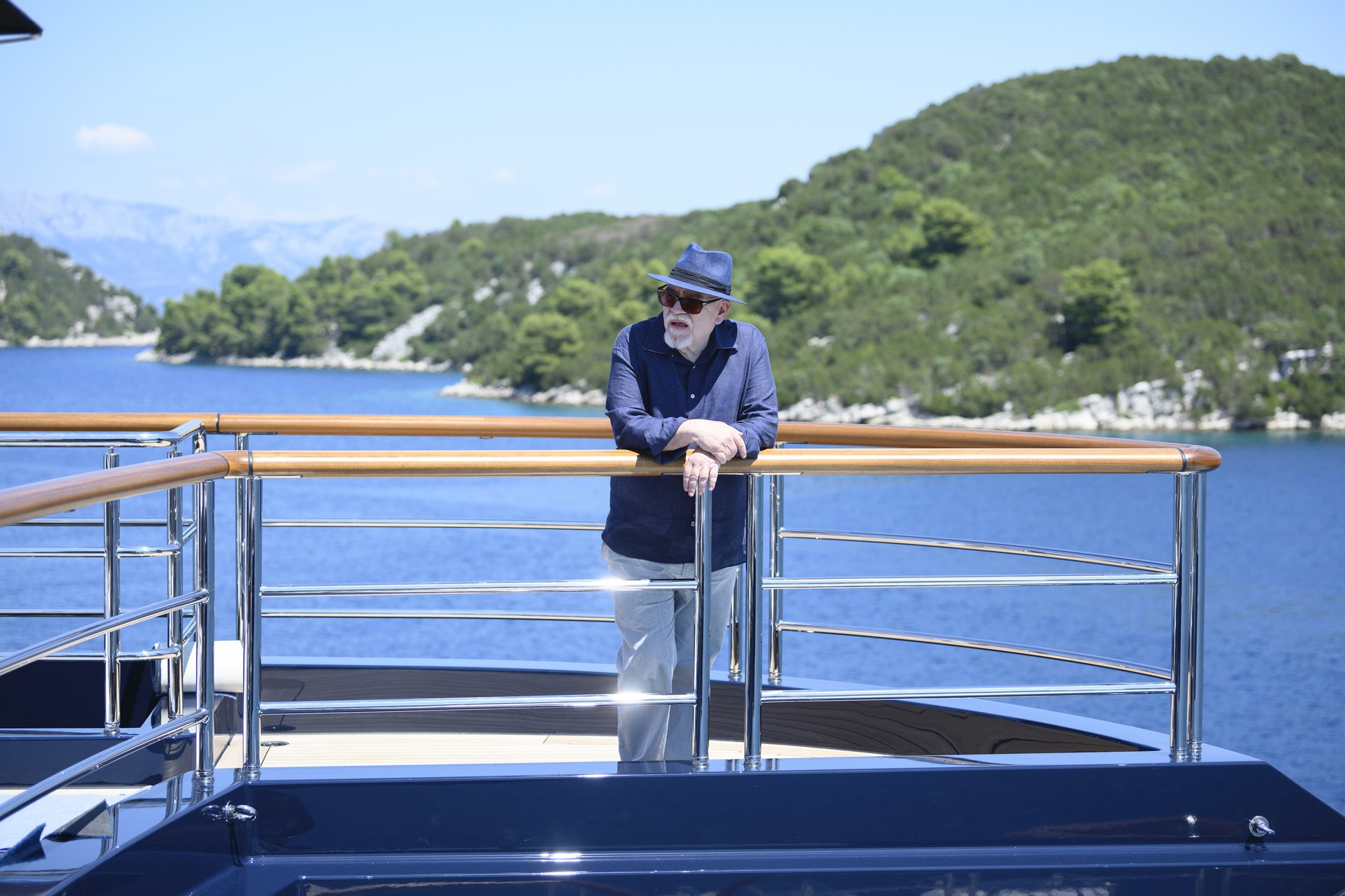 Brian Cox wears a hat on the deck of a yacht on 'Succession.'