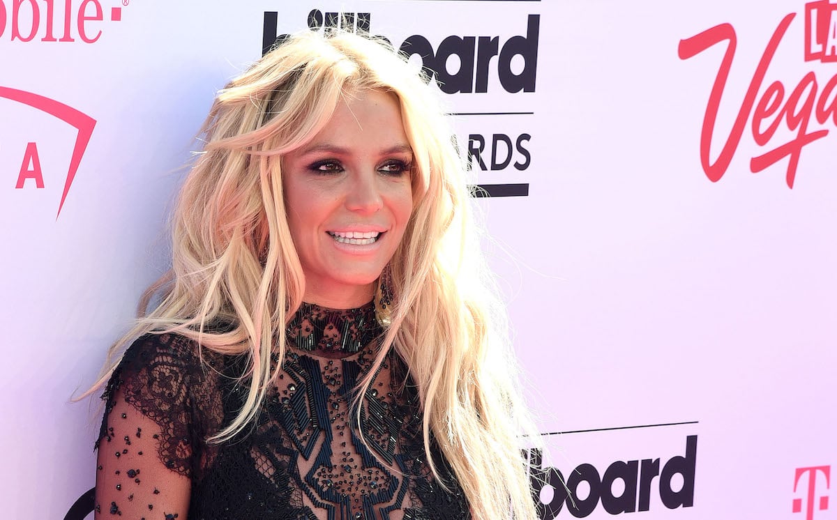 Britney Spears smiling in front of step and repeat