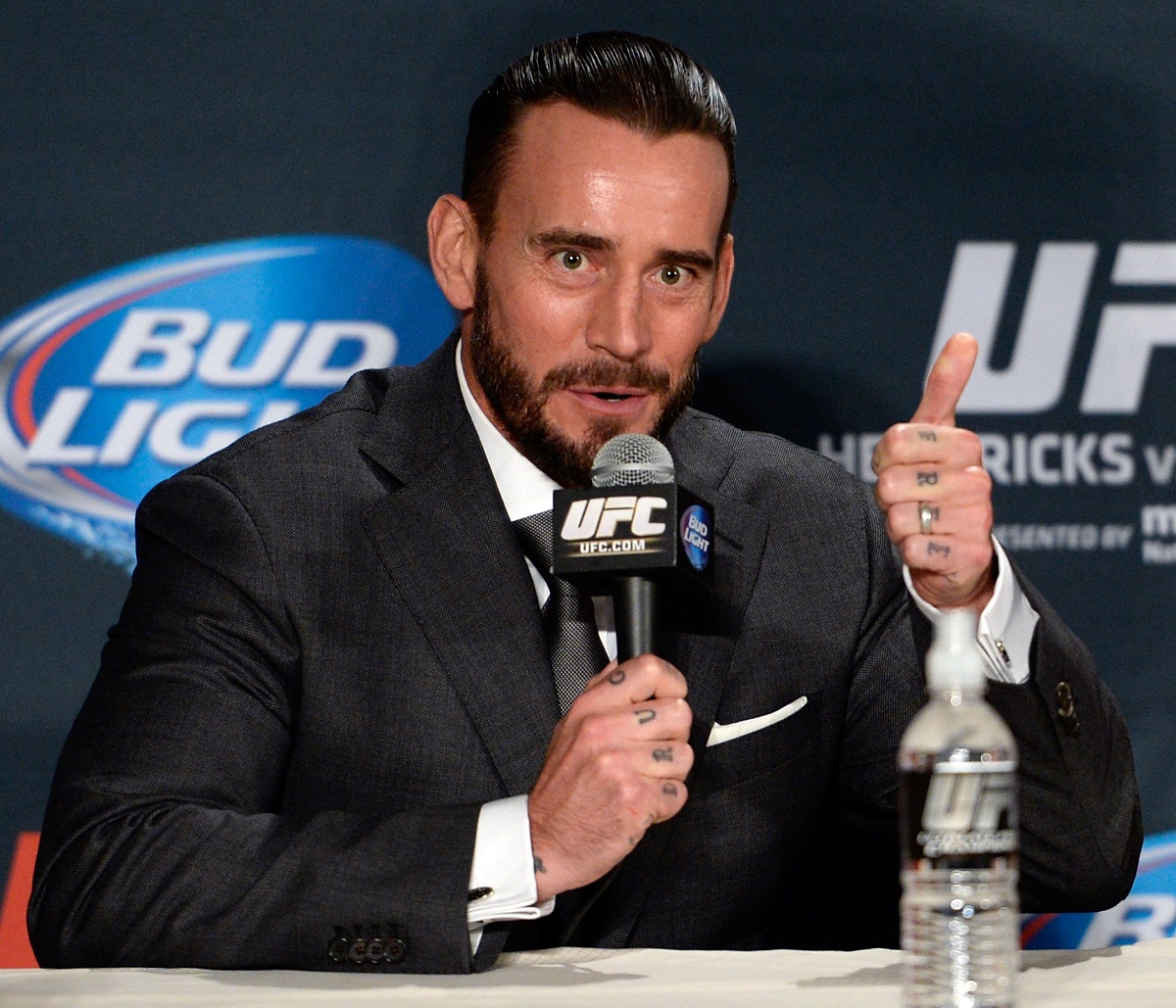 Wrestler CM Punk wears a suit during the 2014 UFC 181 post press conference in Las Vegas.