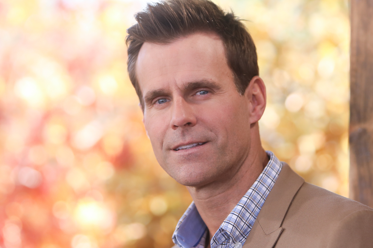 Cameron Mathison looking into camera in front of yellow background