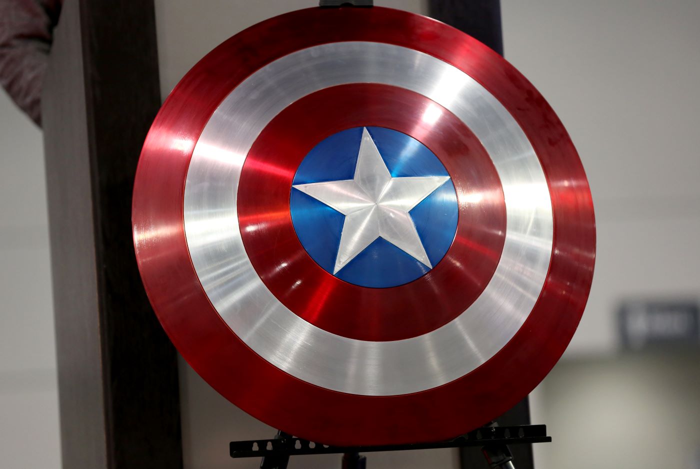 Captain America / Steve Roger's shield on an easel in front of a white and black background