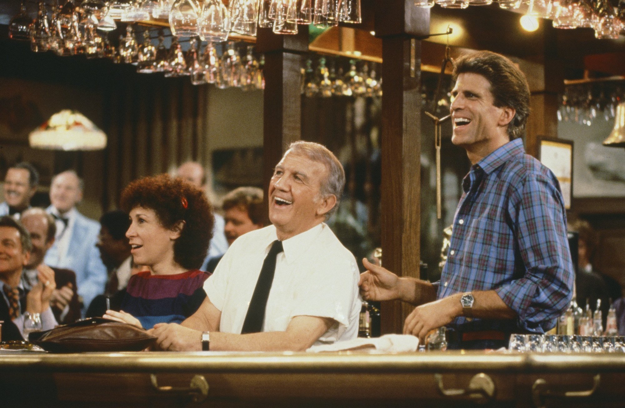 Carla, Coach, and Sam in a scene from 'Cheers' filmed in the bar