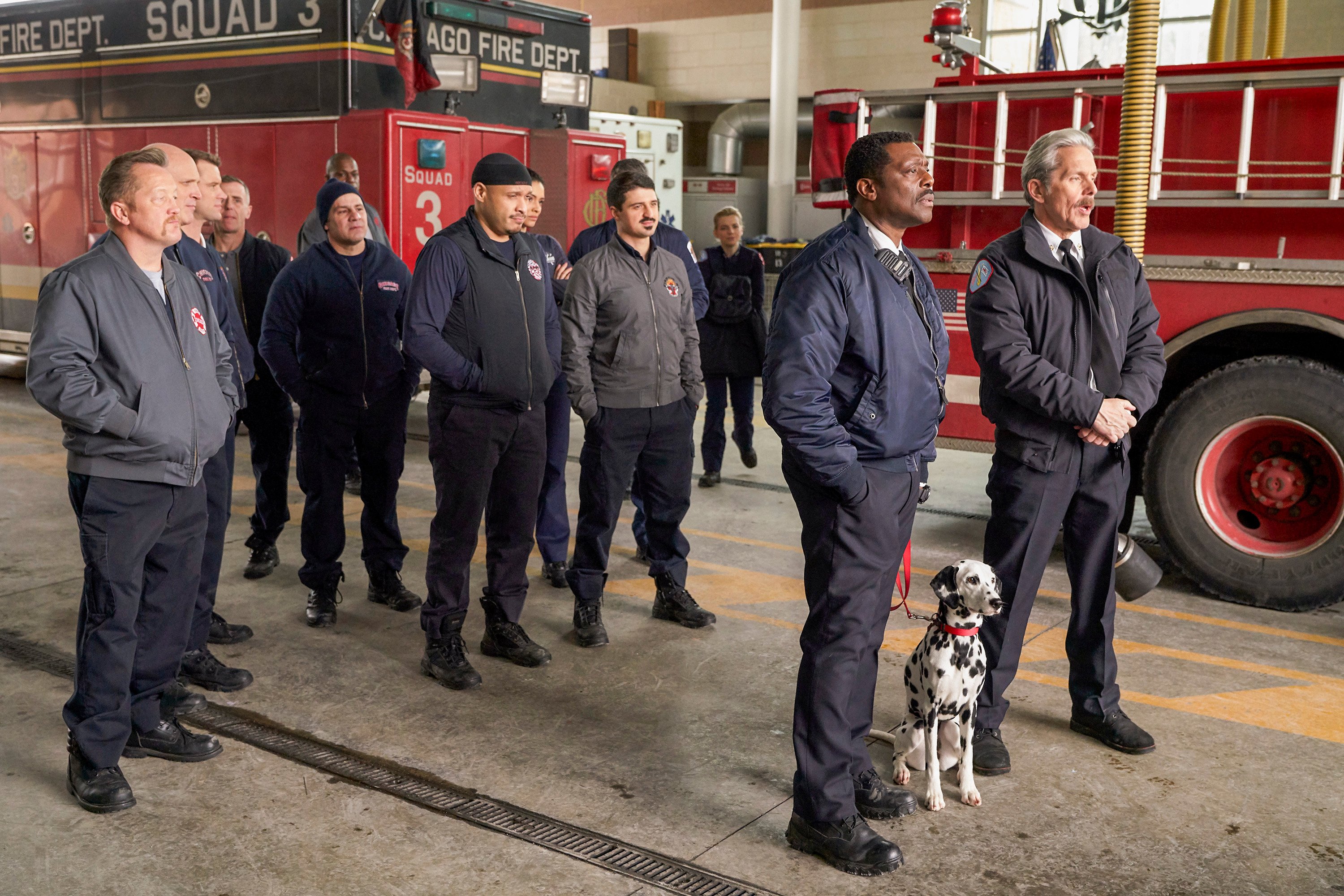 Christian Stolte as Randy "Mouch" McHolland, Joe Minoso as Joe Cruz, Yuri Sardarov as Otis, Eamonn Walker as Wallace Boden and Gary Cole as Chief Grissom stand inside of Firehouse 51