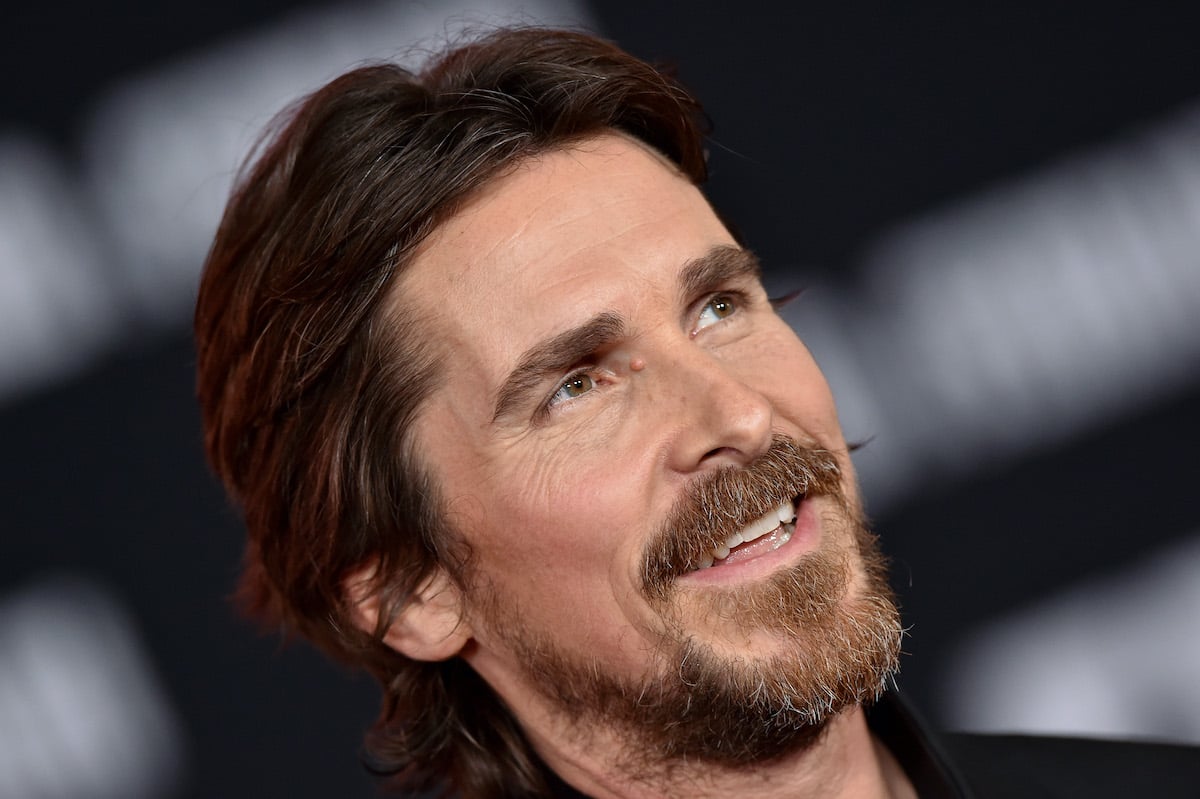Christian Bale wears black and smiles on the red carpet