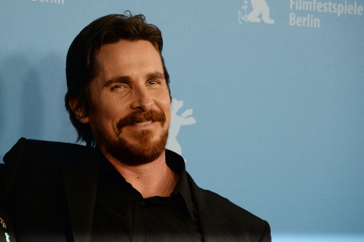 Christian Bale wears black and smiles