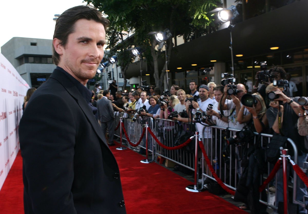 Christian Bale smiles and poses on the red carpet