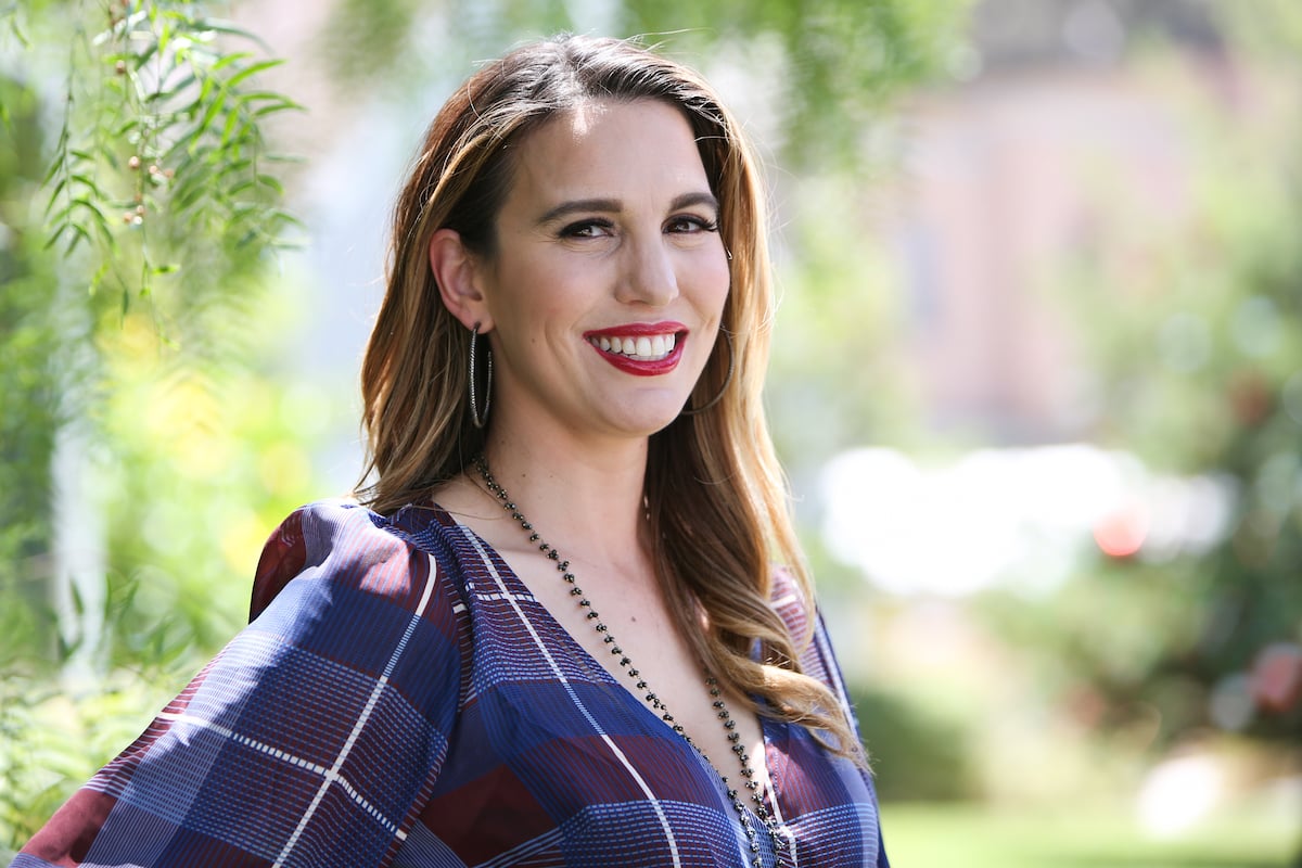Christy Carlson Romano outdoors in plaid purple top