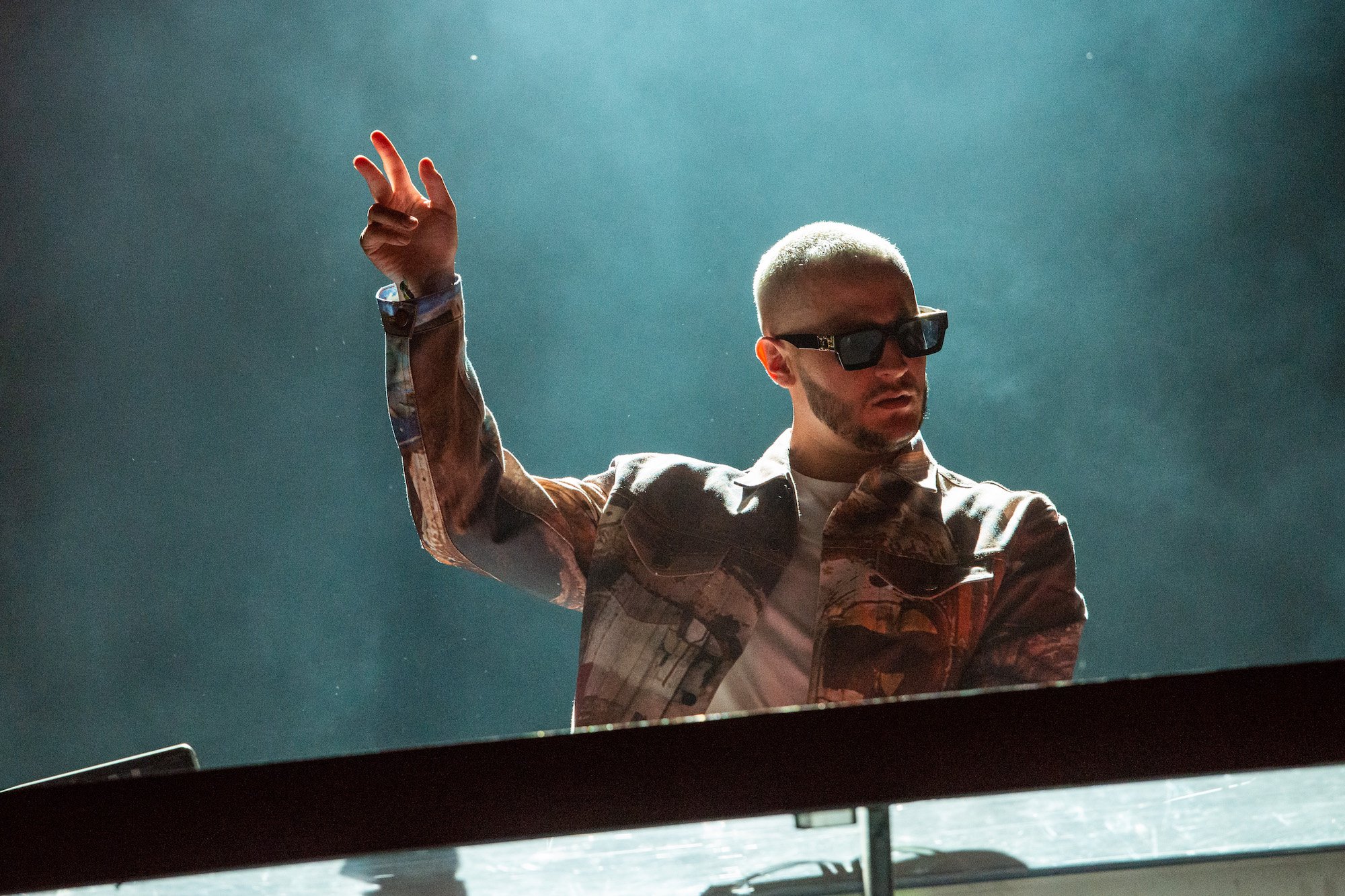 DJ Snake performing on a smoky stage