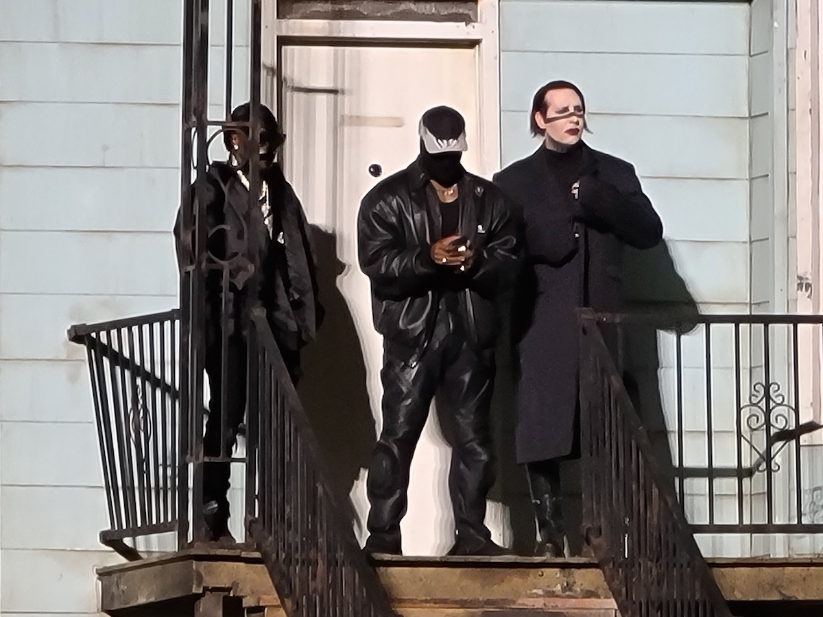 DaBaby, Kanye West and Marilyn Manson on the porch of a replica of West's childhood home on stage at West's "Donda" listening event.