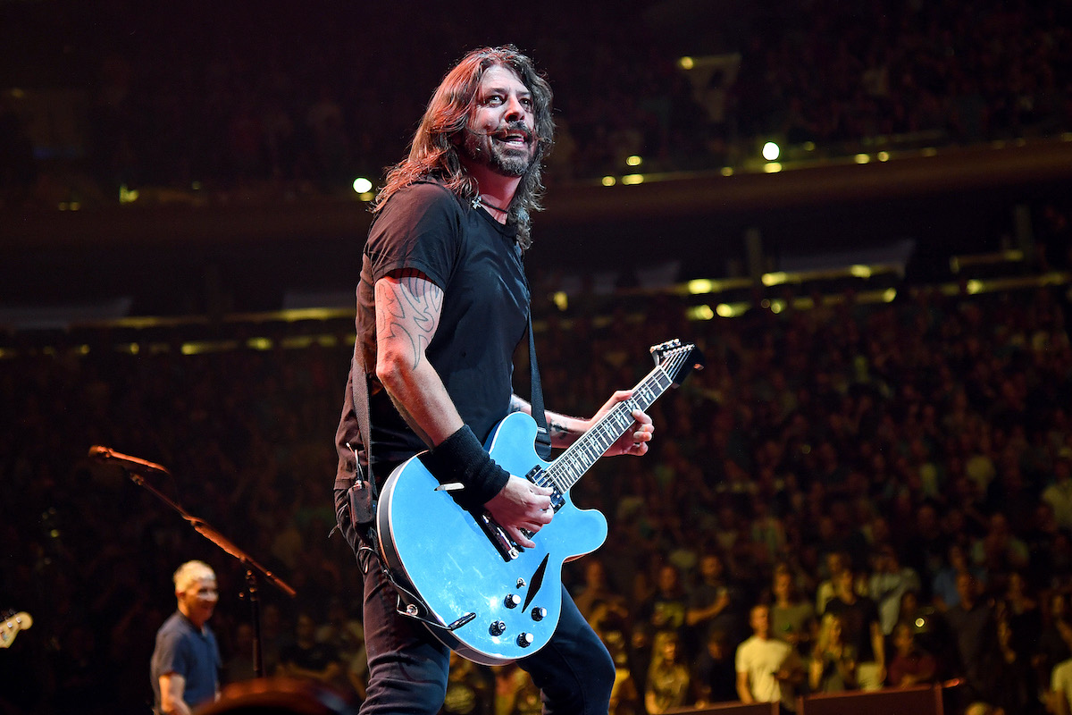 Dave Grohl playing guitar on stage.