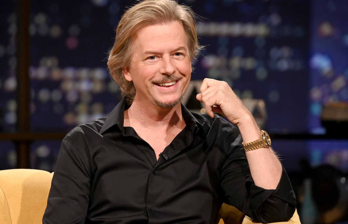 David Spade faces the camera, smiling.