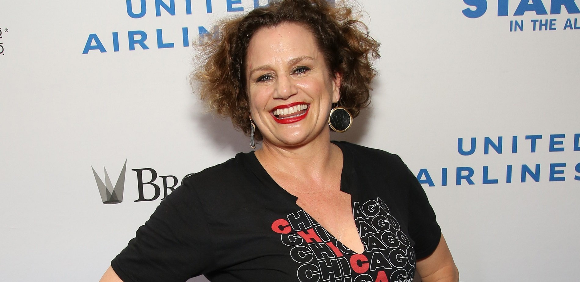 Broadway veteran Cady Huffman pictured from the chest up smiling and wearing a black shirt that says Chicago