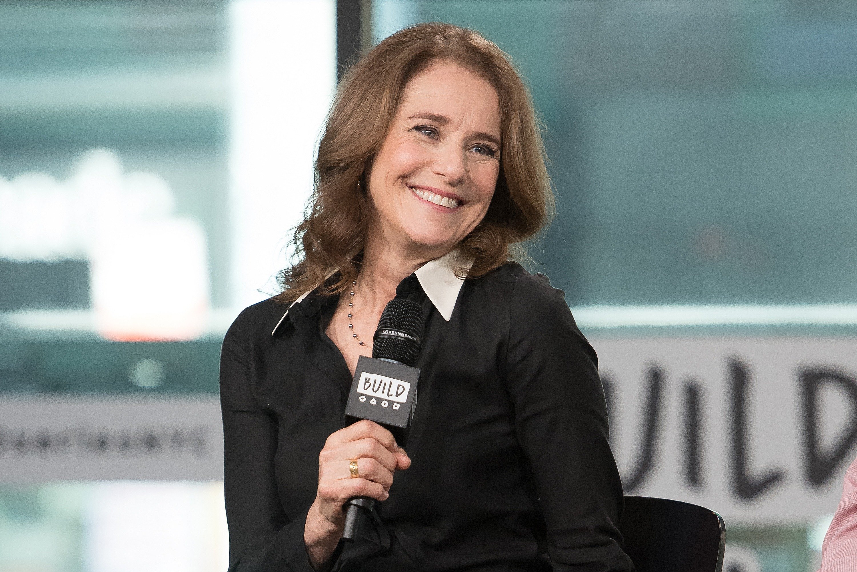 Debra Winger talking with a microphone