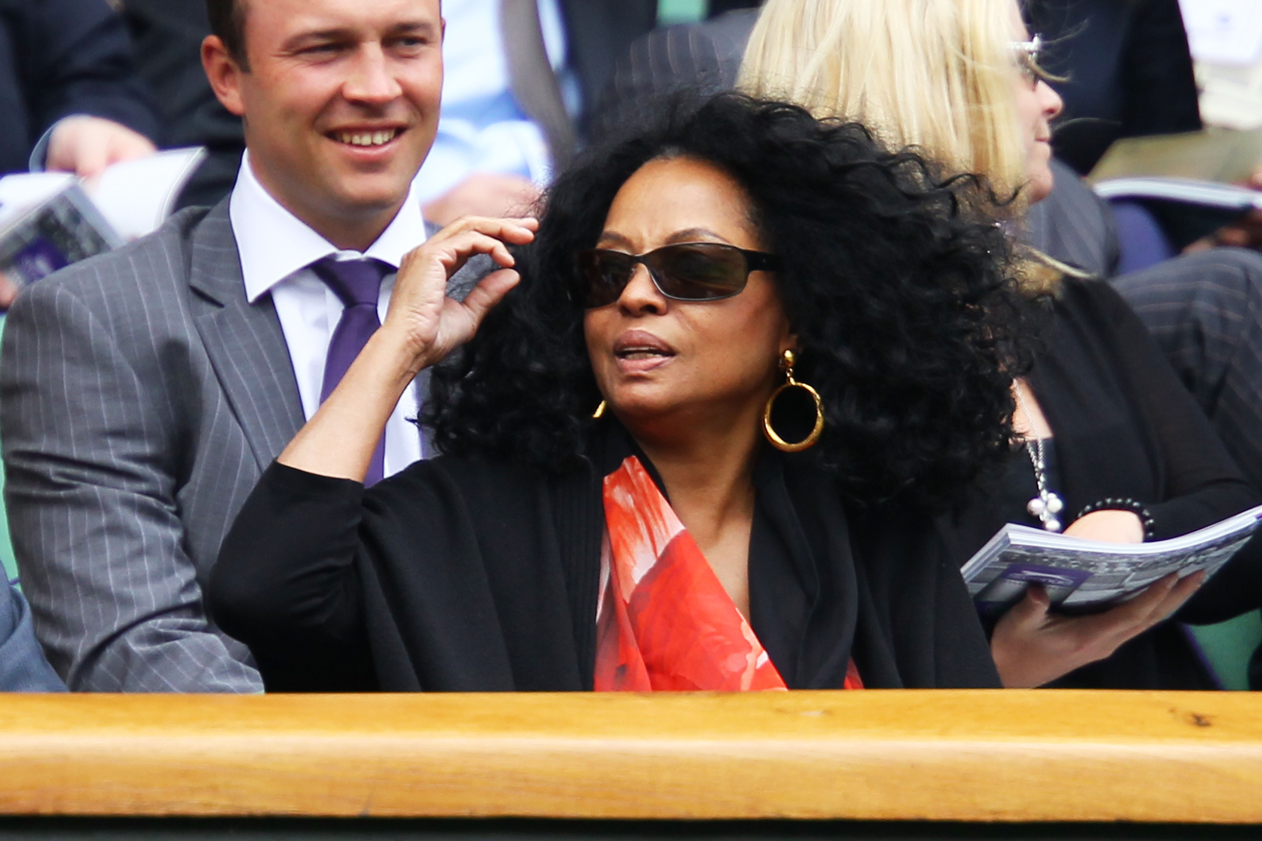 Diana Ross wearing sunglasses and a scarf at Wimbledon.