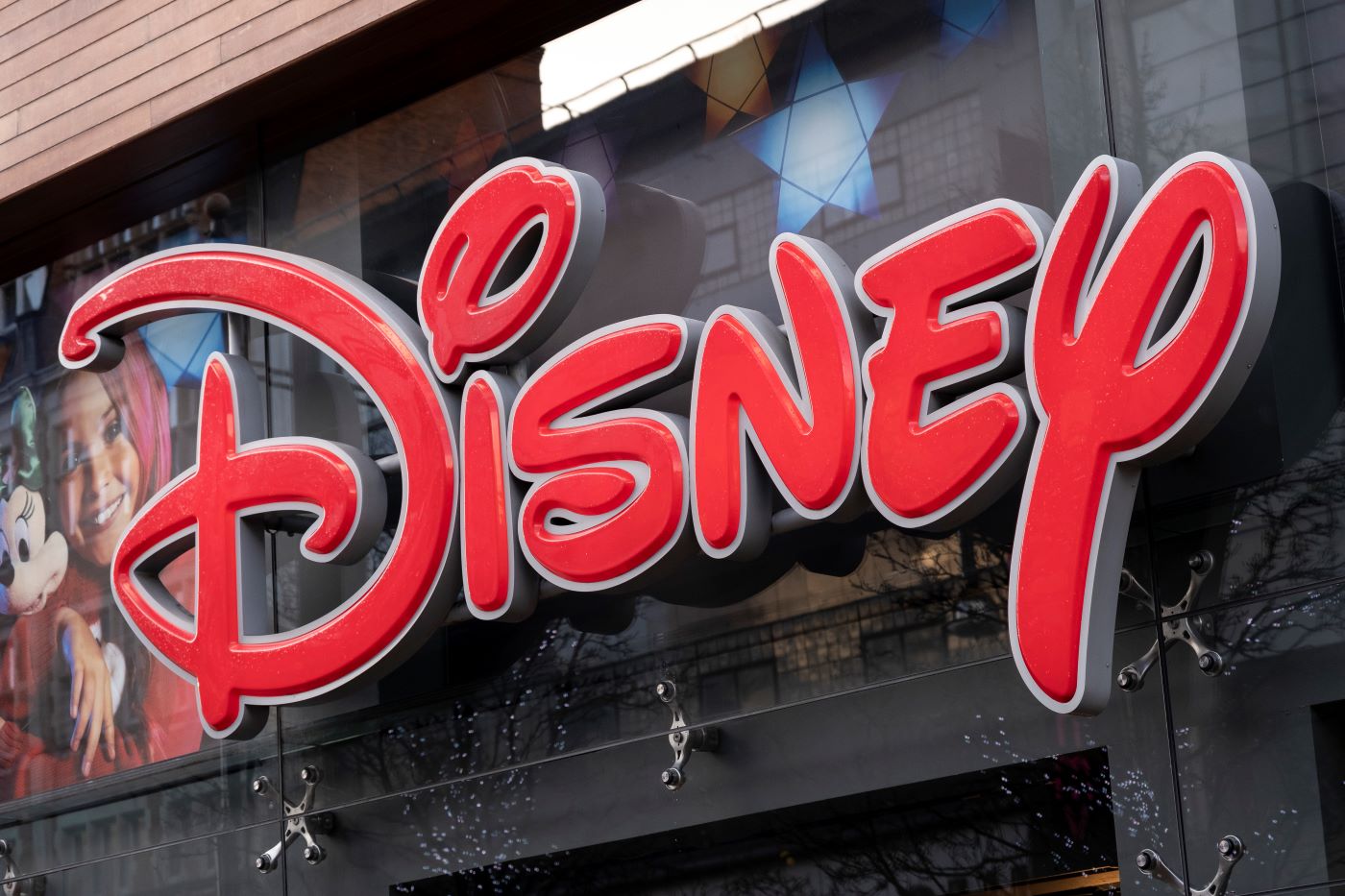 A Disney sign written in red on a black building.
