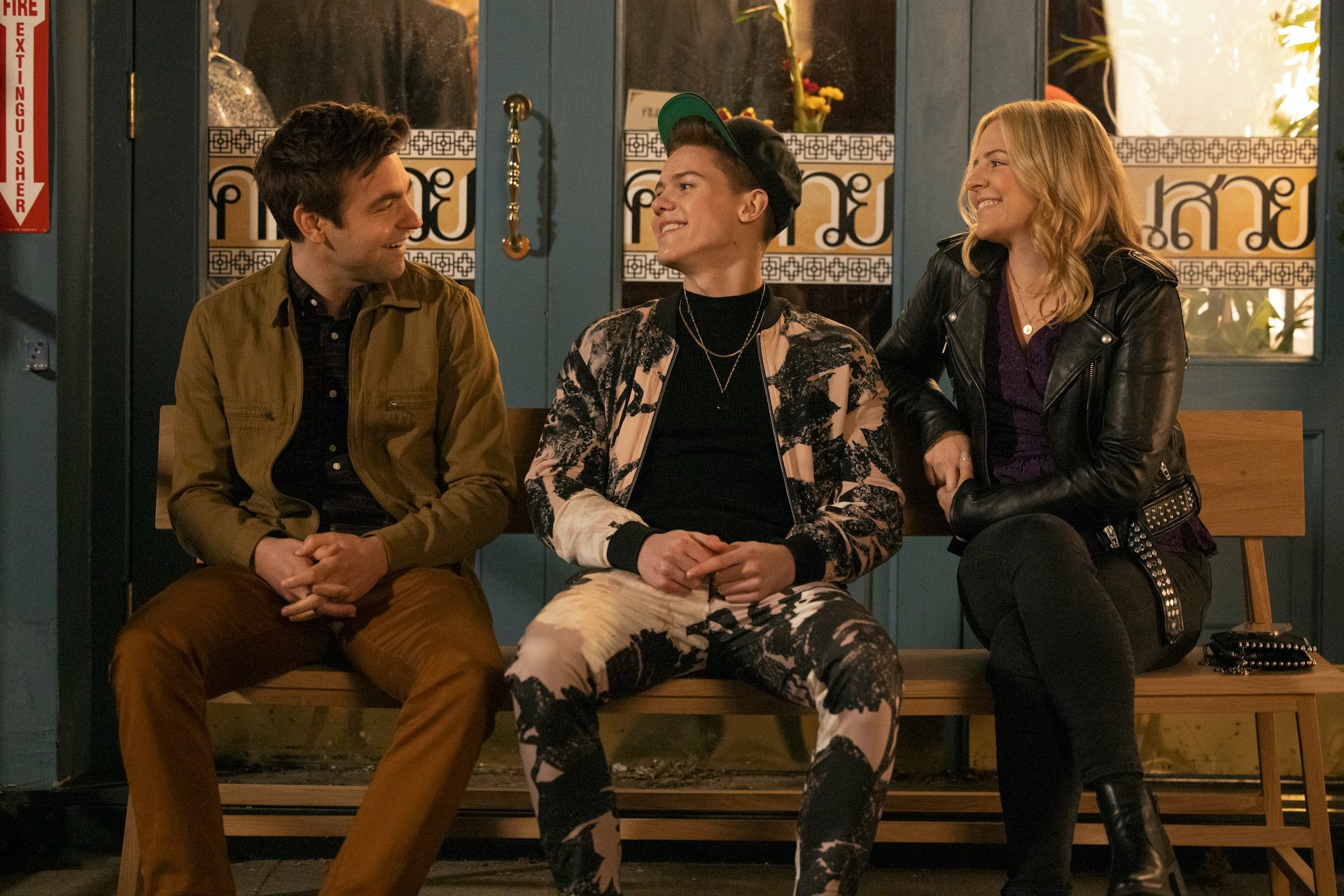 Drew Tarver, Case Walker, and Heléne Yorke sit on a bench outside in 'The Other Two.'