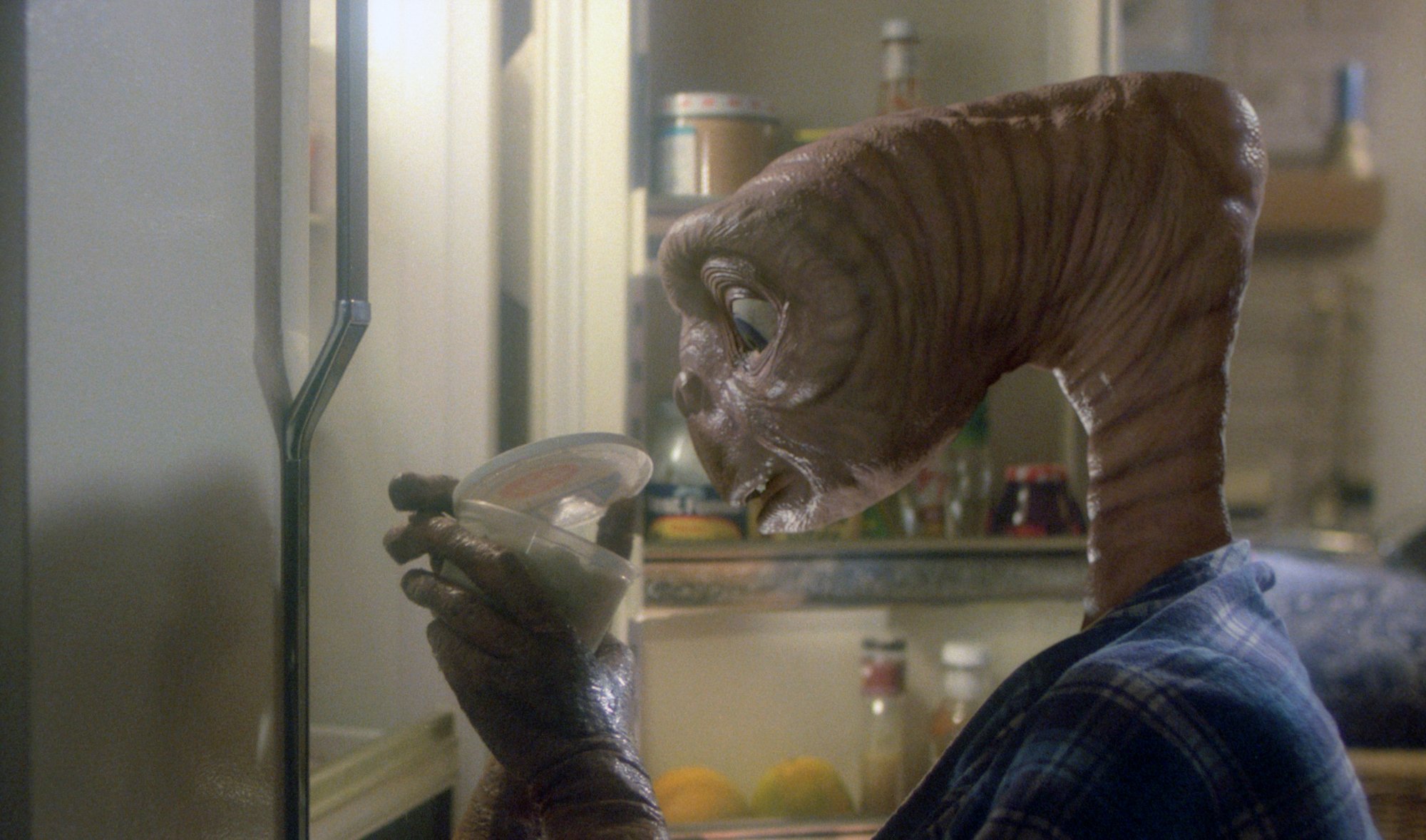 E.T. looking in the fridge in a still from 'E.T.'