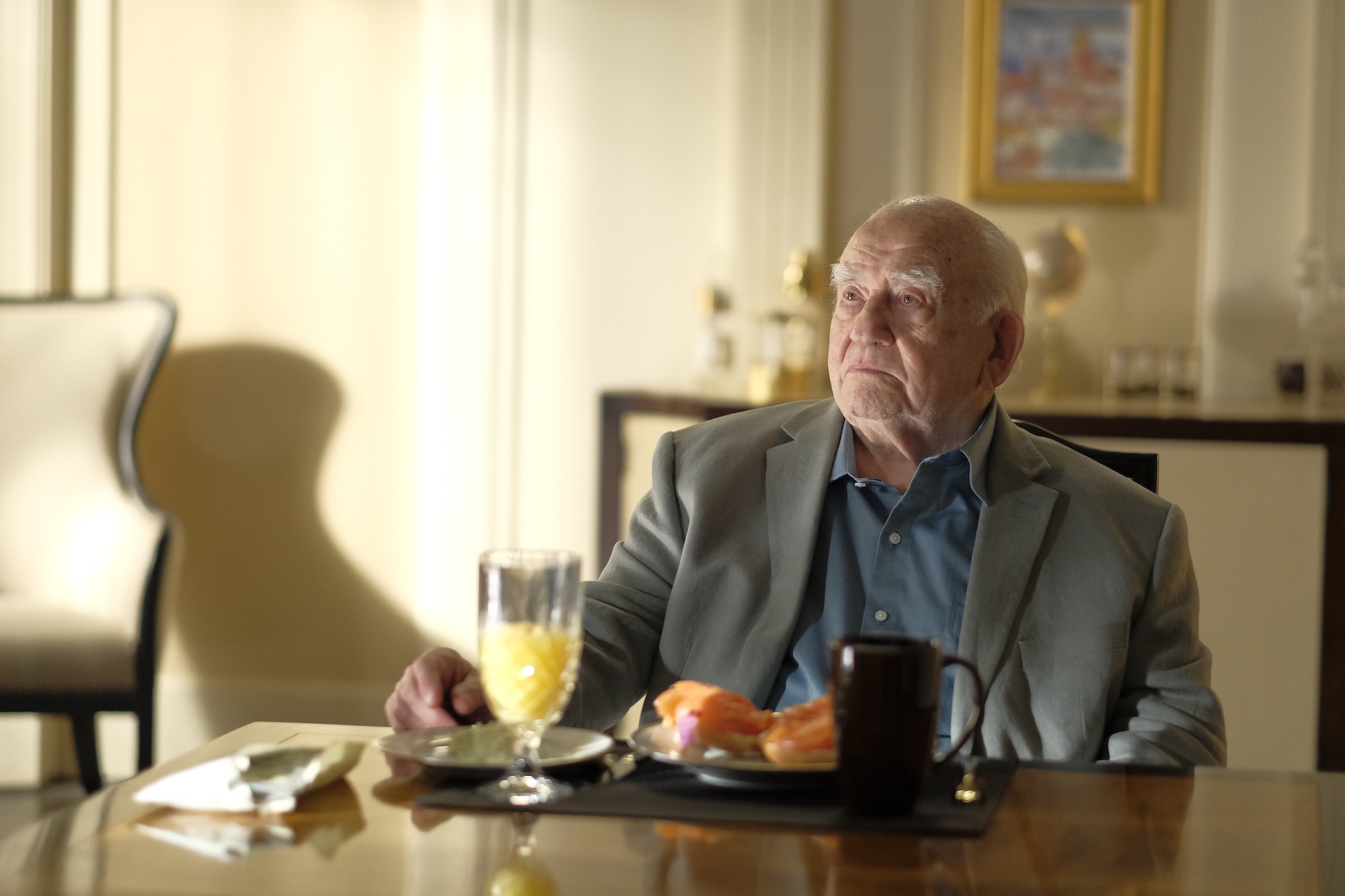 Ed Asner sits at his breakfast table on Cobra Kai