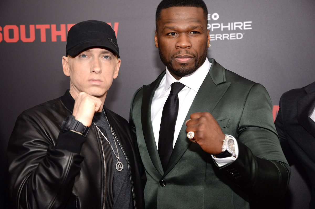 Eminem and Curtis "50 Cent" Jackson raise their fists on the red carpet