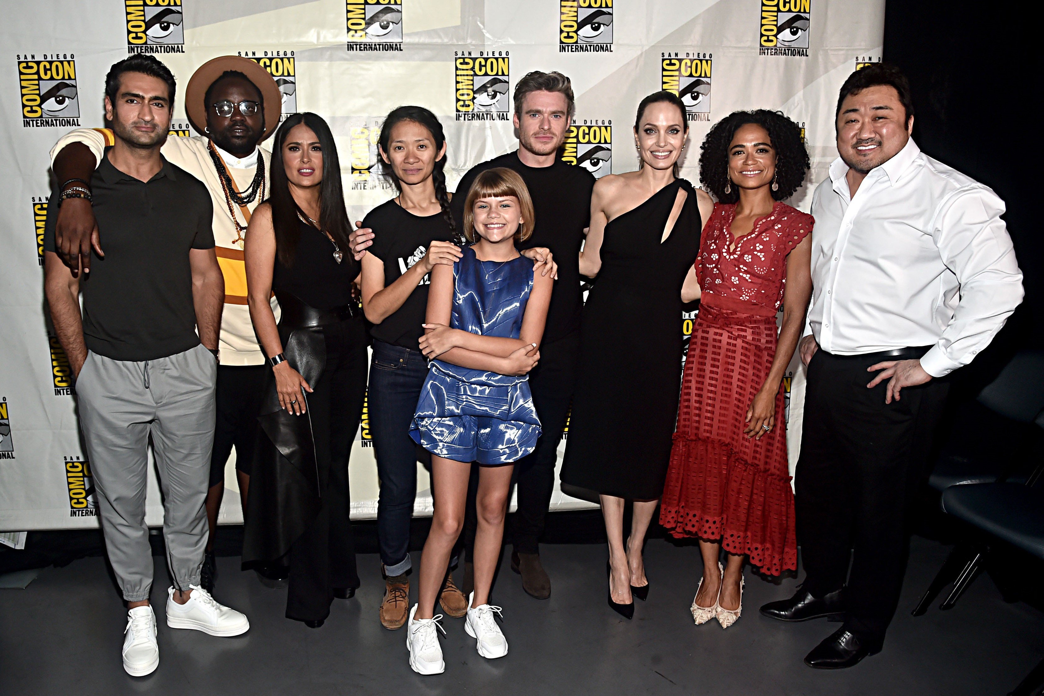 SAN DIEGO, CALIFORNIA - JULY 20: (L-R) Kumail Nanjiani, Brian Tyree Henry, Salma Hayek, Director Chloe Zhao, Lia McHugh, Richard Madden, Angelina Jolie, Lauren Ridloff and Don Lee of Marvel Studios' 'The Eternals' at the San Diego Comic-Con International 2019 Marvel Studios Panel in Hall H on July 20, 2019 in San Diego, California.