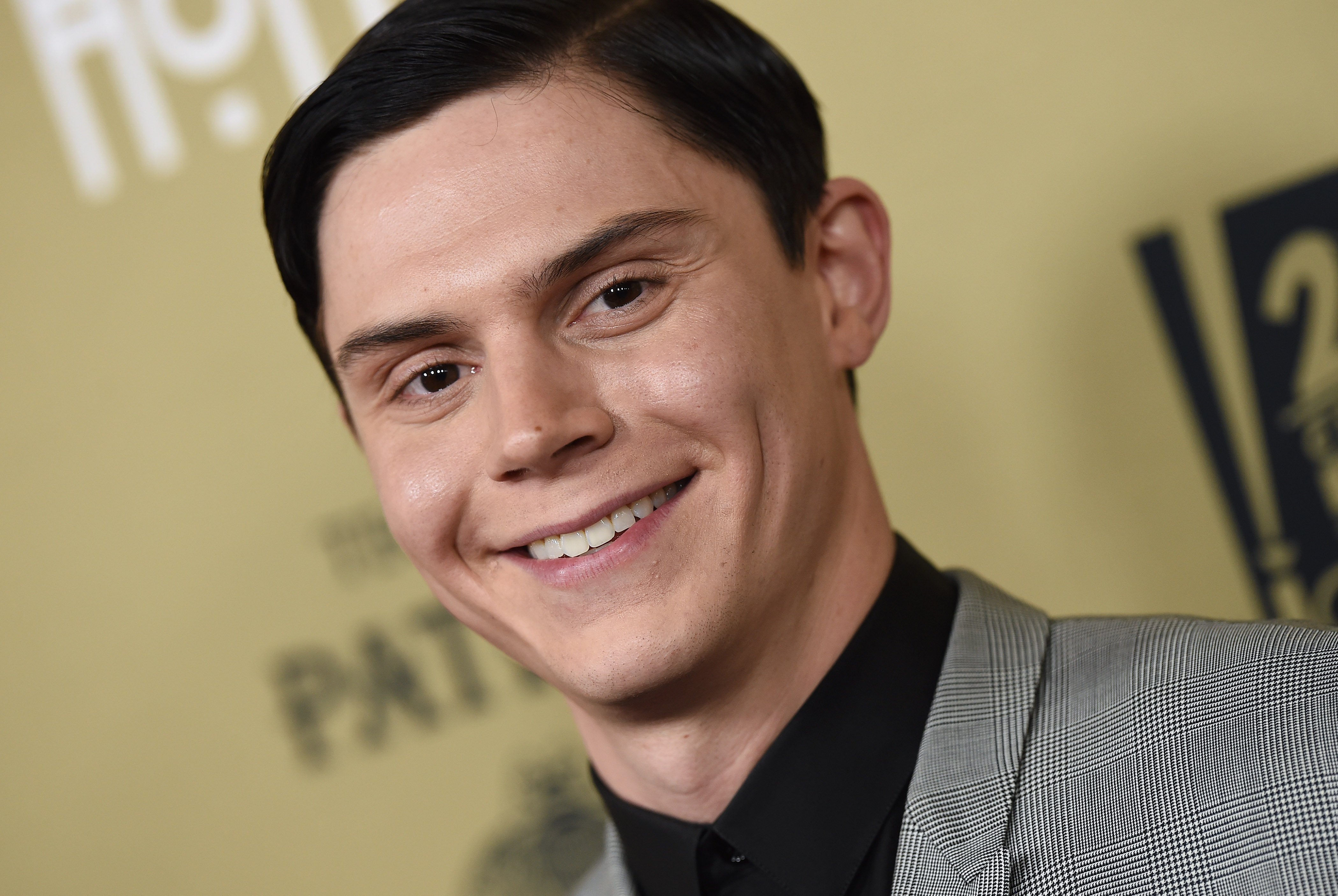 Actor Evan Peters arrives at the premiere screening of FX's 'American Horror Story: Hotel' smiling for picture