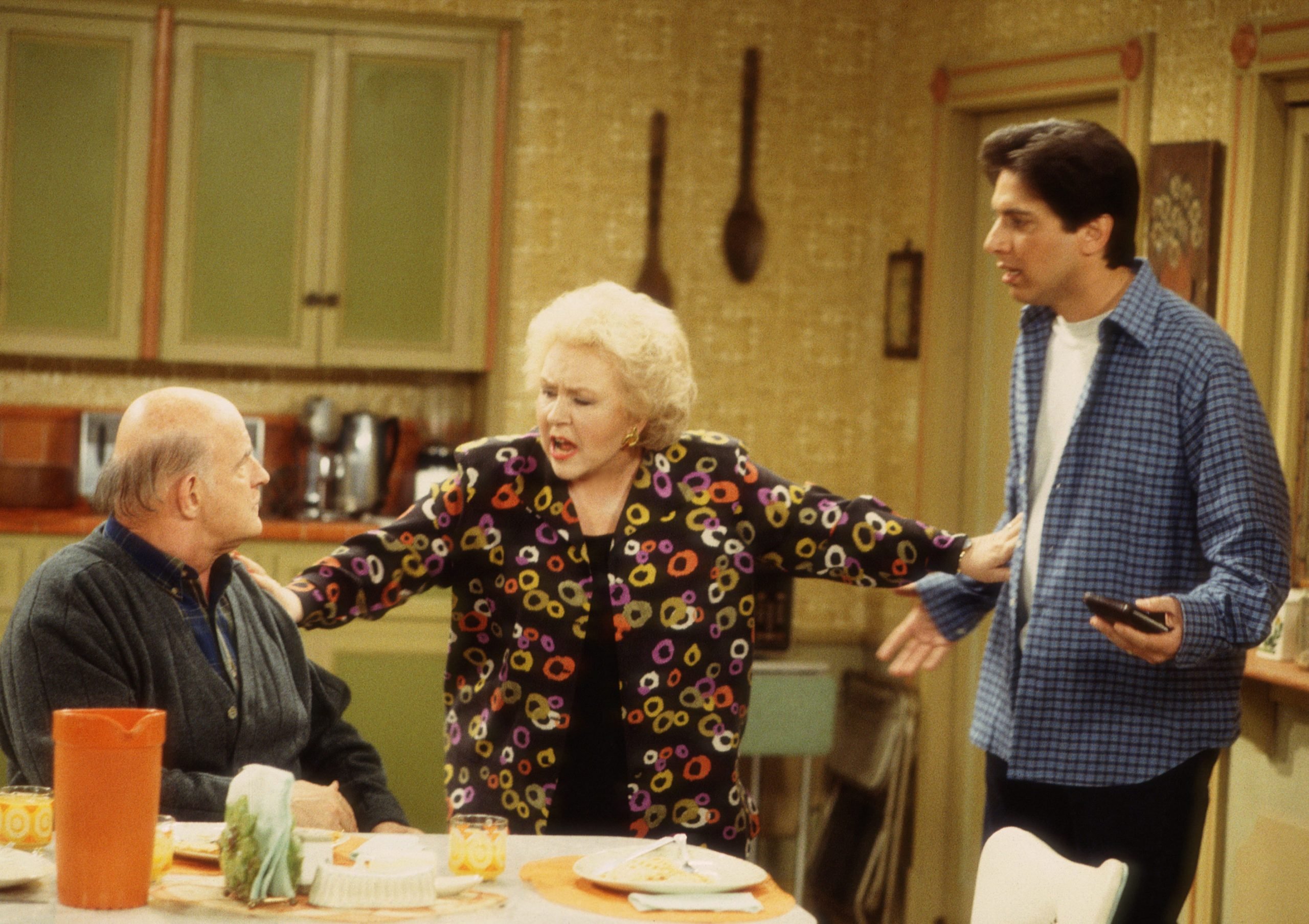(Left to right): Actors Peter Boyle, Doris Roberts, and Ray Romano in a scene from the classic comedy.