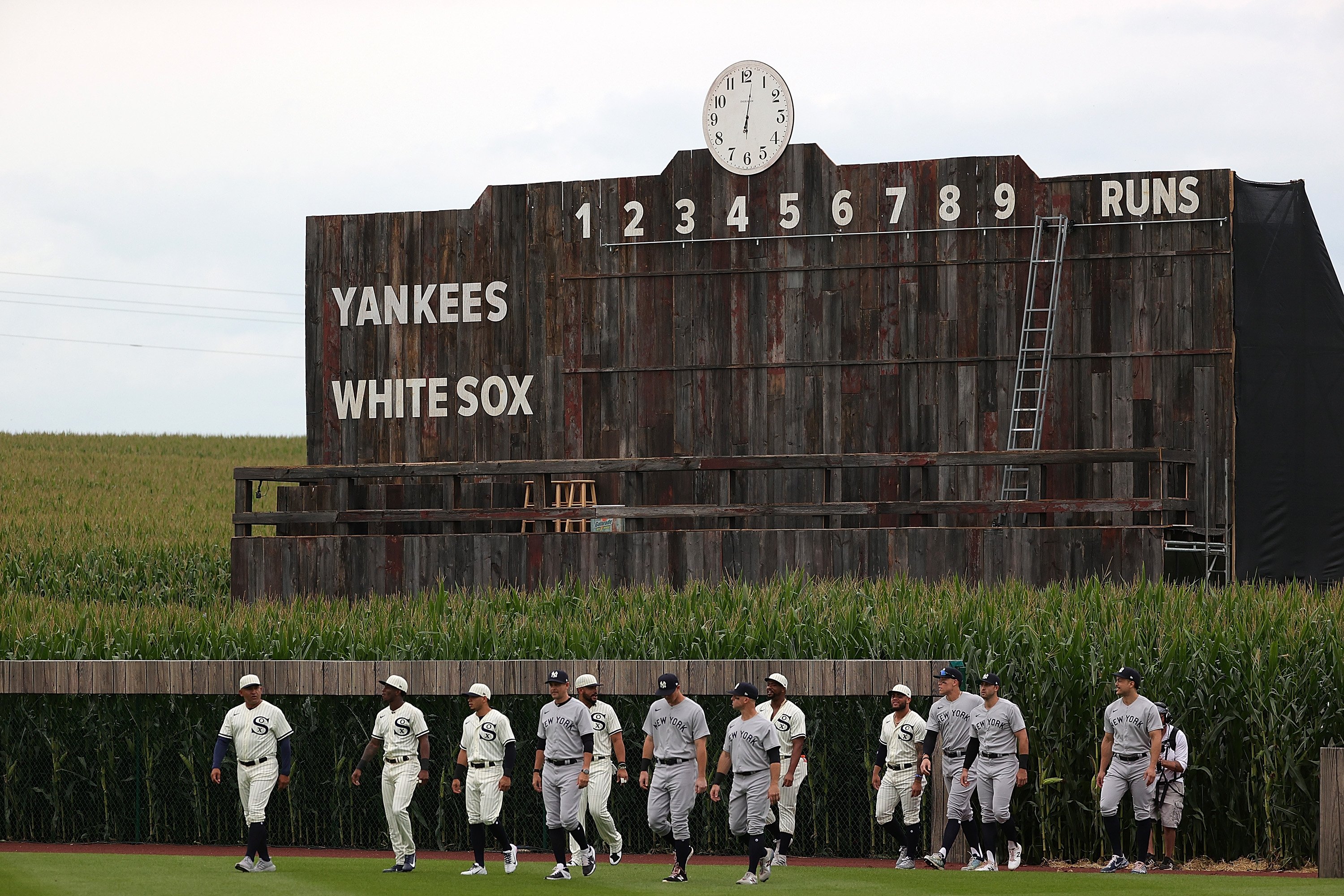 Members of the Chicago White Sox and the New York Yankees take the field prior to a game at the Field of Dreams