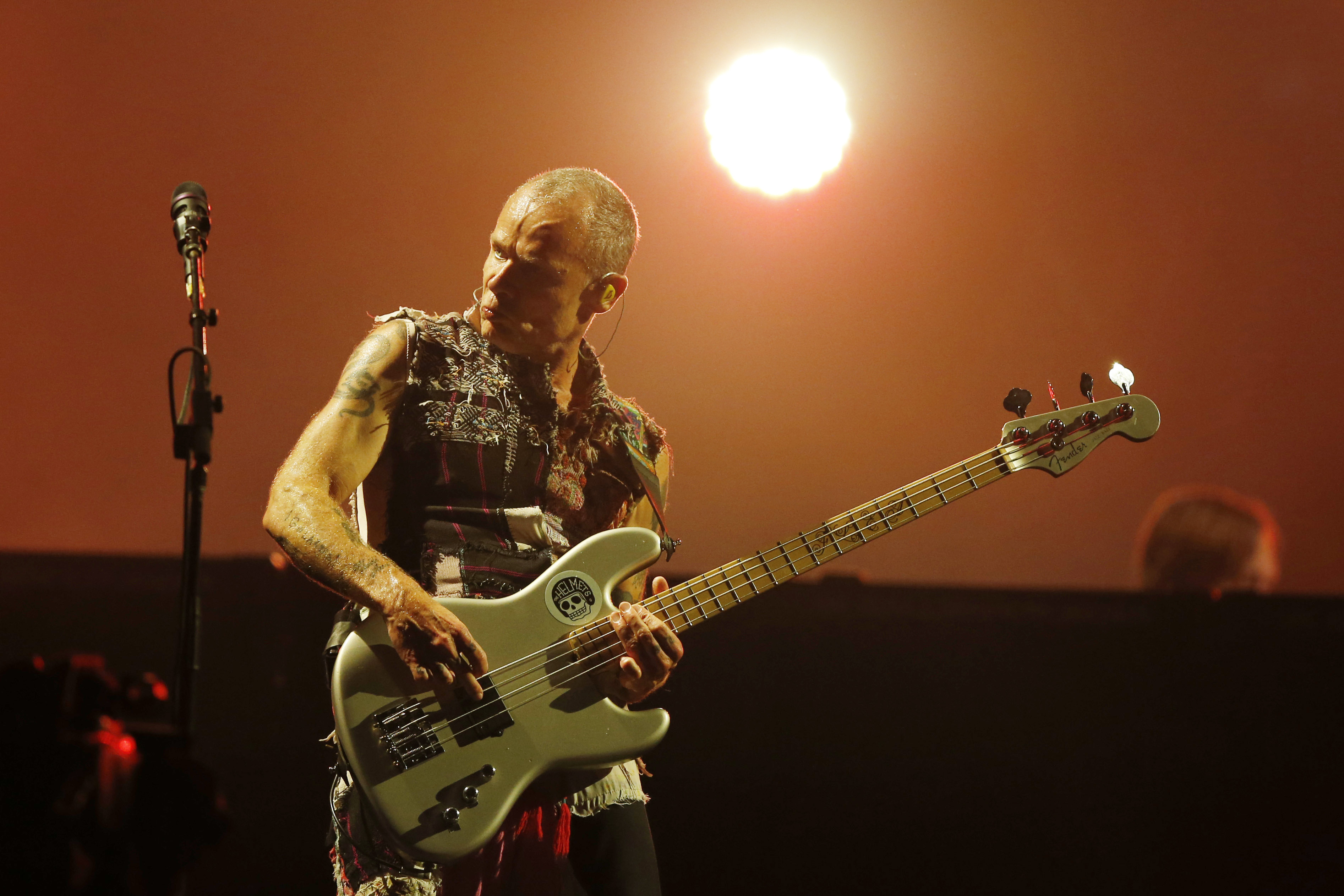 Flea plays guitar on stage in Rio