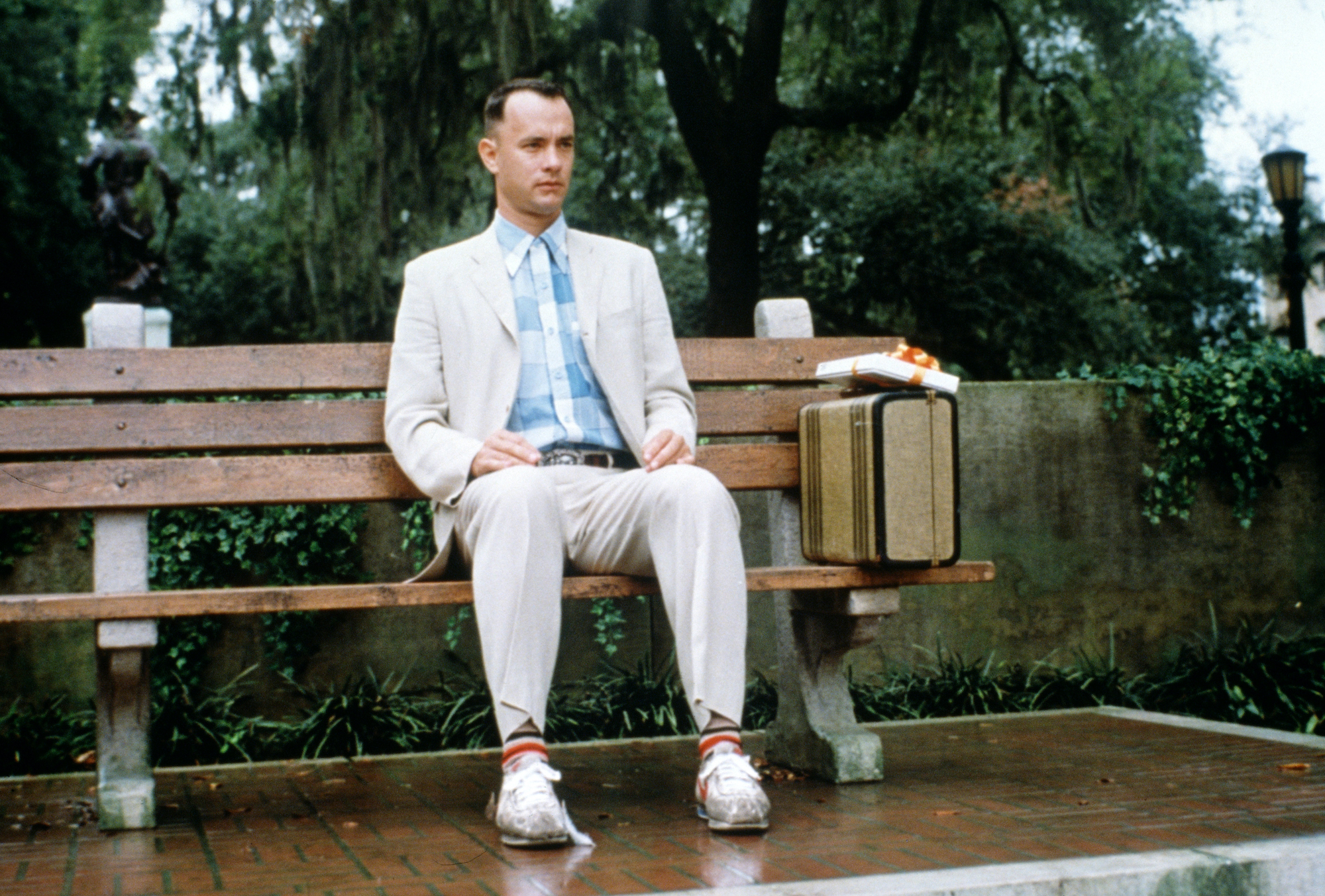 Tom Hanks sitting on a bench in a scene from 'Forrest Gump'