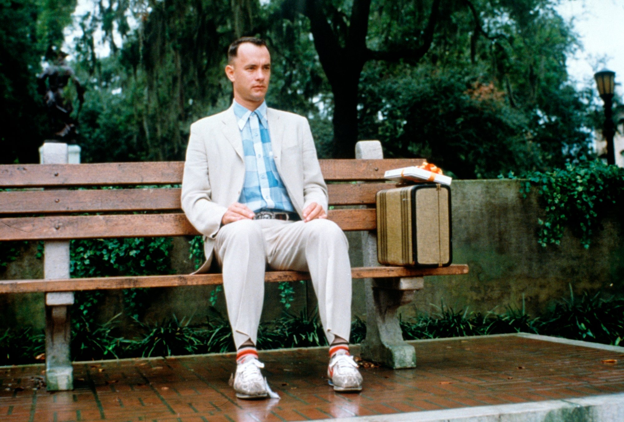 Tom Hanks sitting on a bench in a scene from 'Forrest Gump'