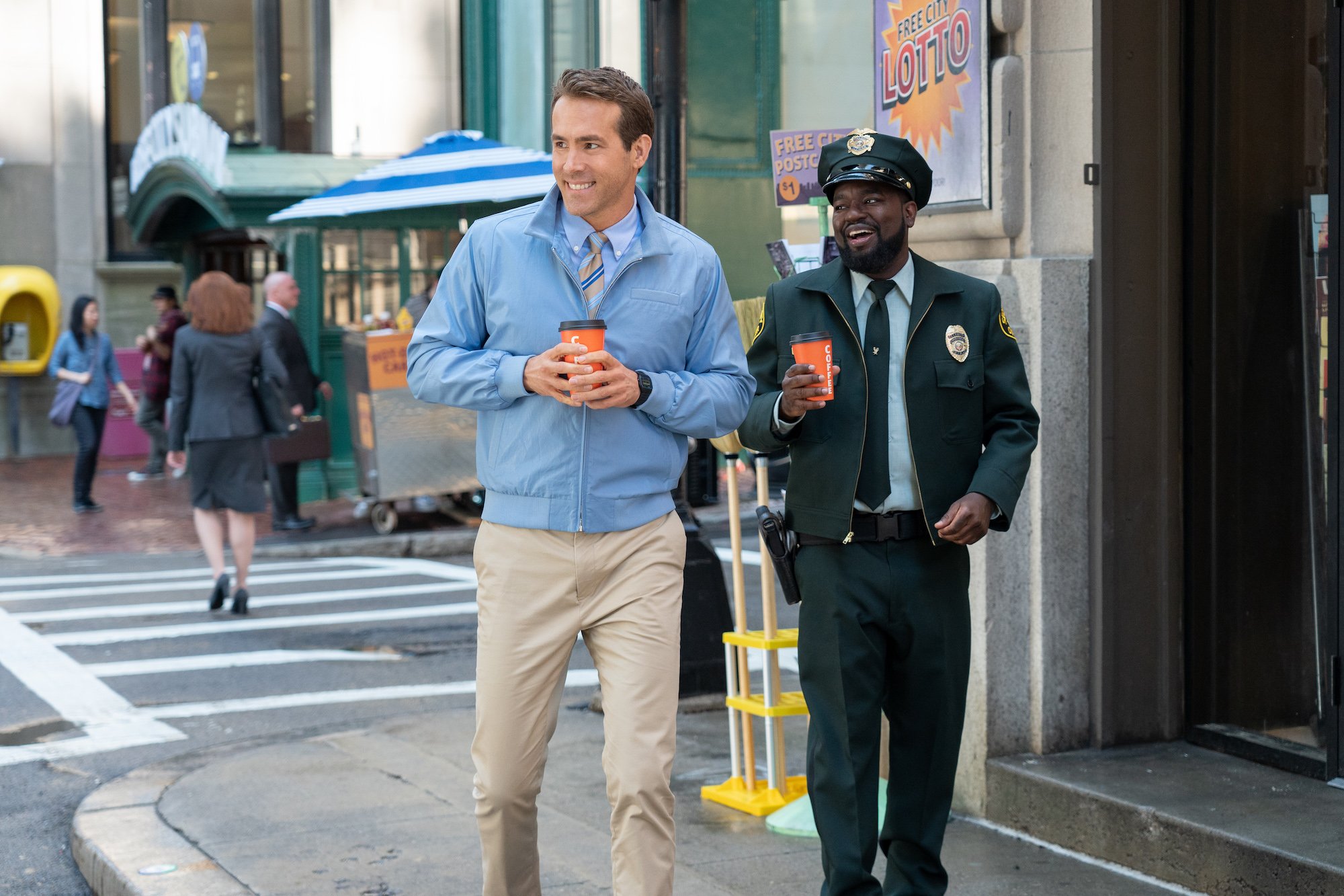 Free Guy: Ryan Reynolds and Lil Rel Howery walk down the street
