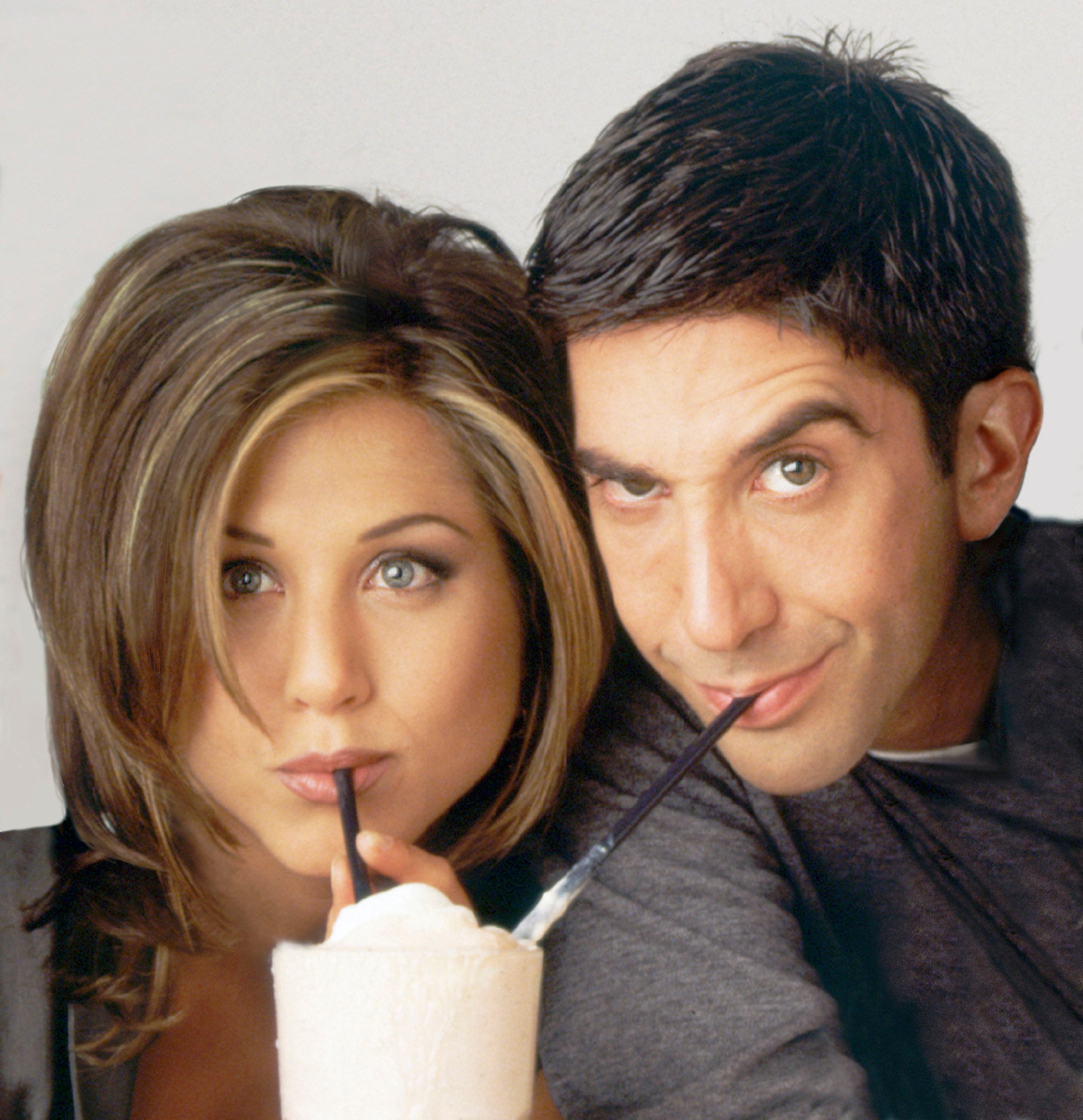 Jennifer Aniston and David Schwimmer pose together drinking a milkshake during a promotional shoot for 'Friends'