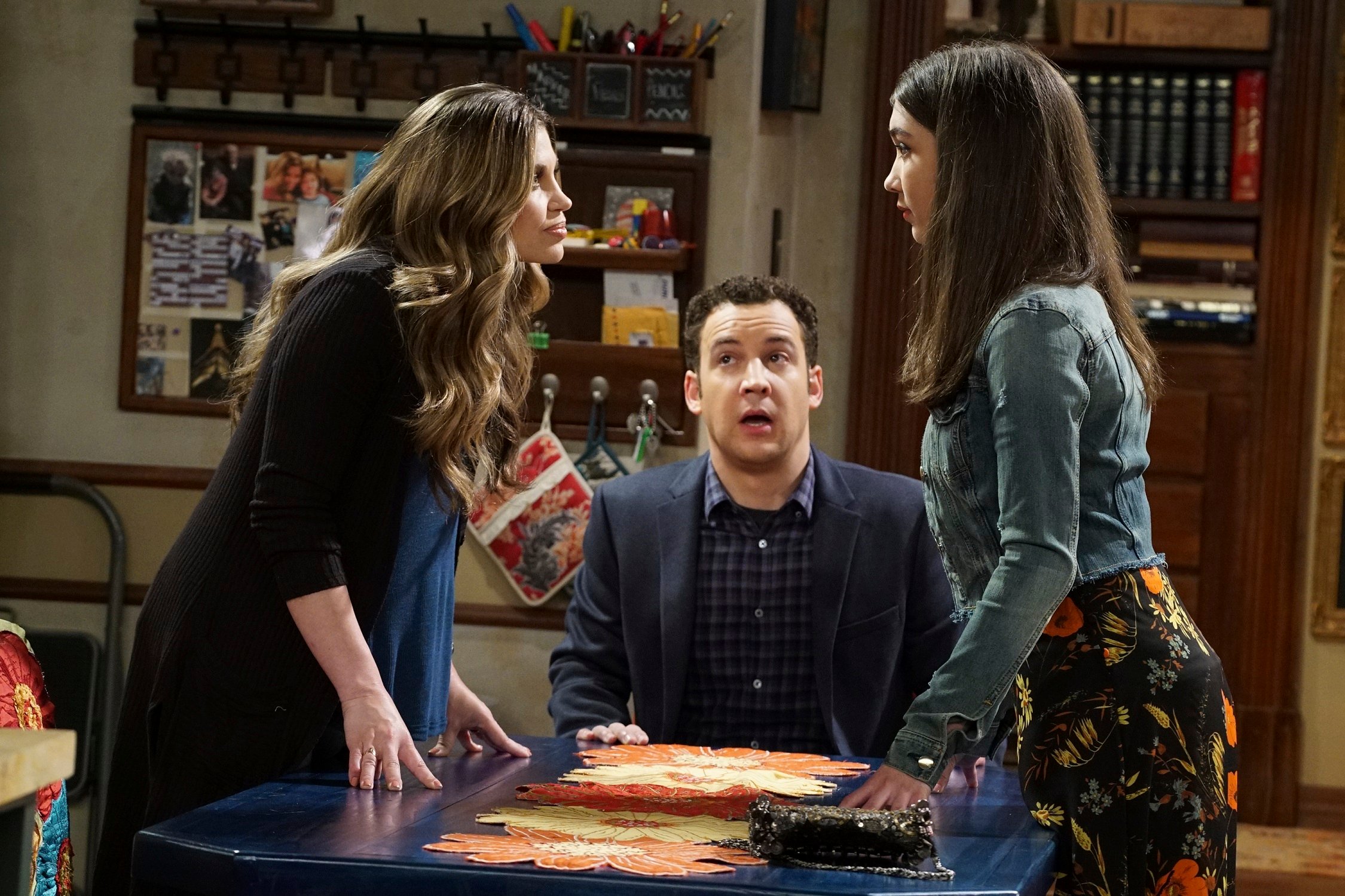 Danielle Fishel as Topanga and Rowan Blanchard as Riley argue at the table while Ben Savage as Cory stands by in 'Girl Meets World'