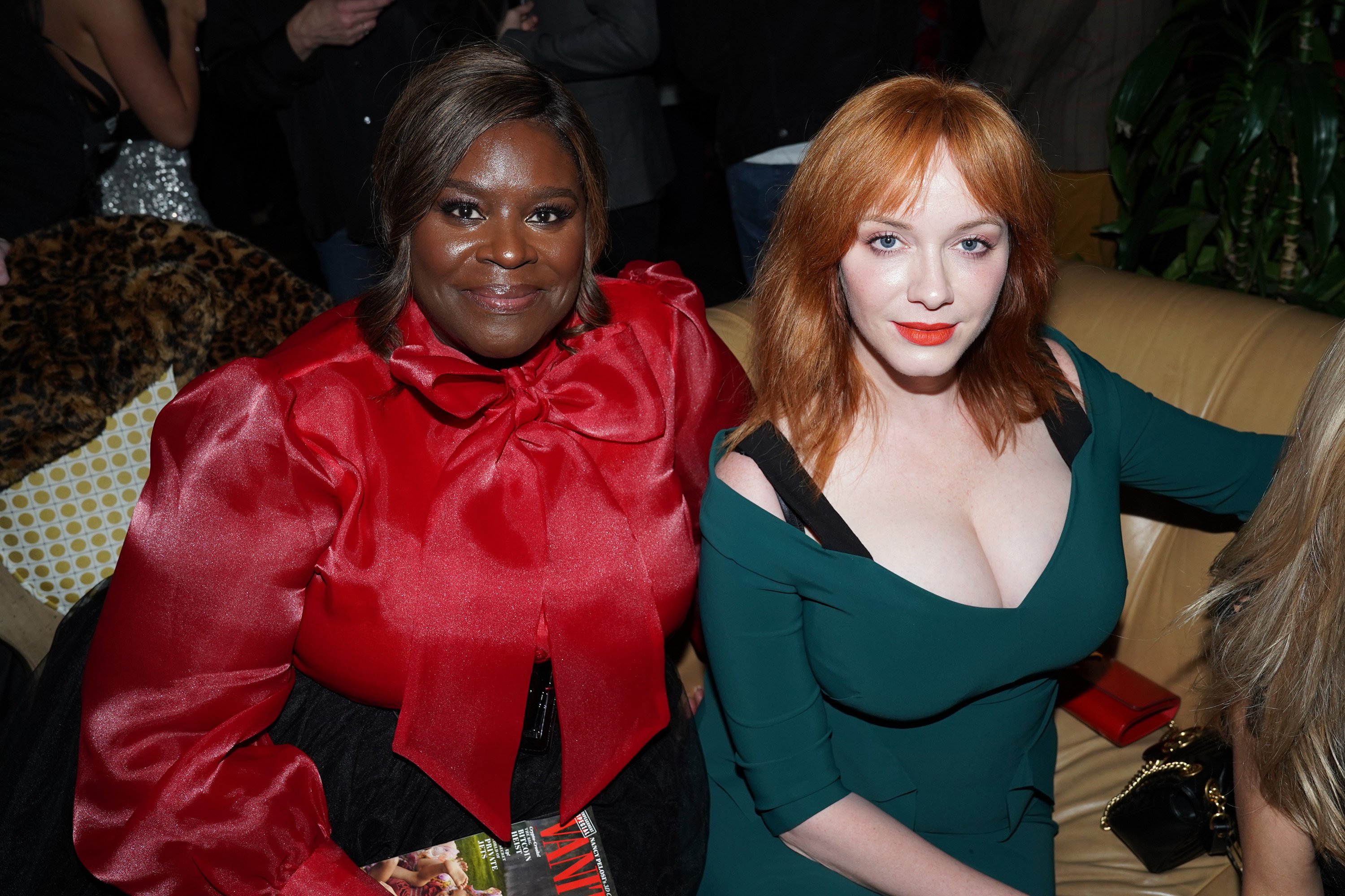 'Good Girls' cast members Retta and Christina Hendricks smiling at the camera at a Vanity Fair party.