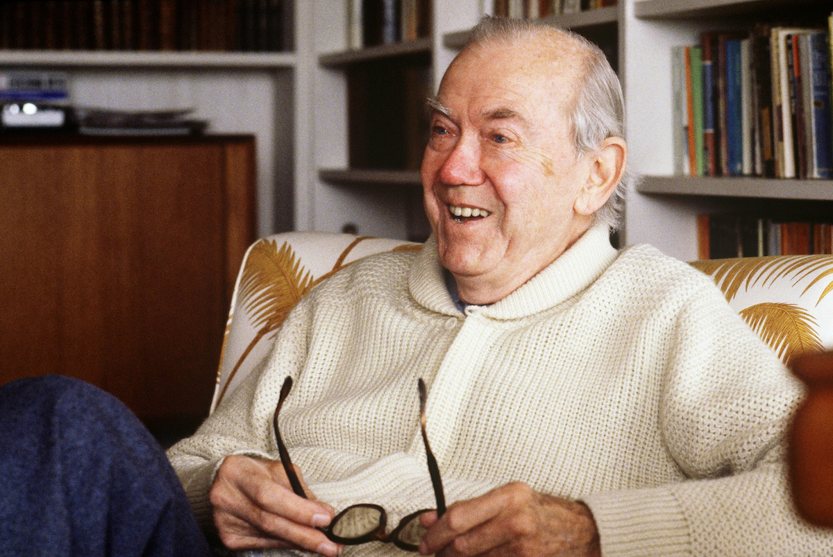 Graham Greene sitting with glasses