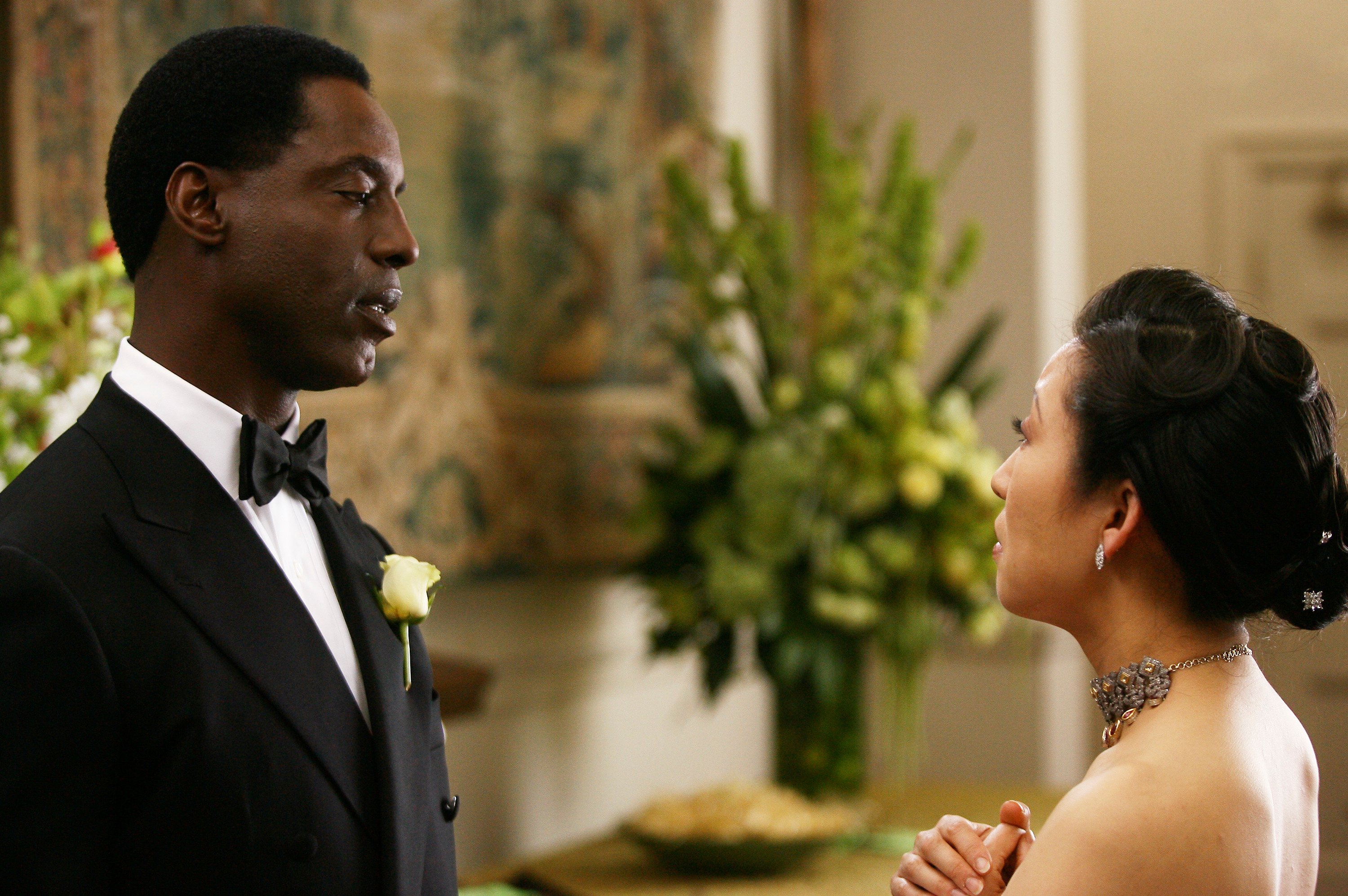 'Grey's Anatomy' actors Isaiah Washington as Preston Burke and Sandra Oh as Cristina Yang staring intensely at each other.