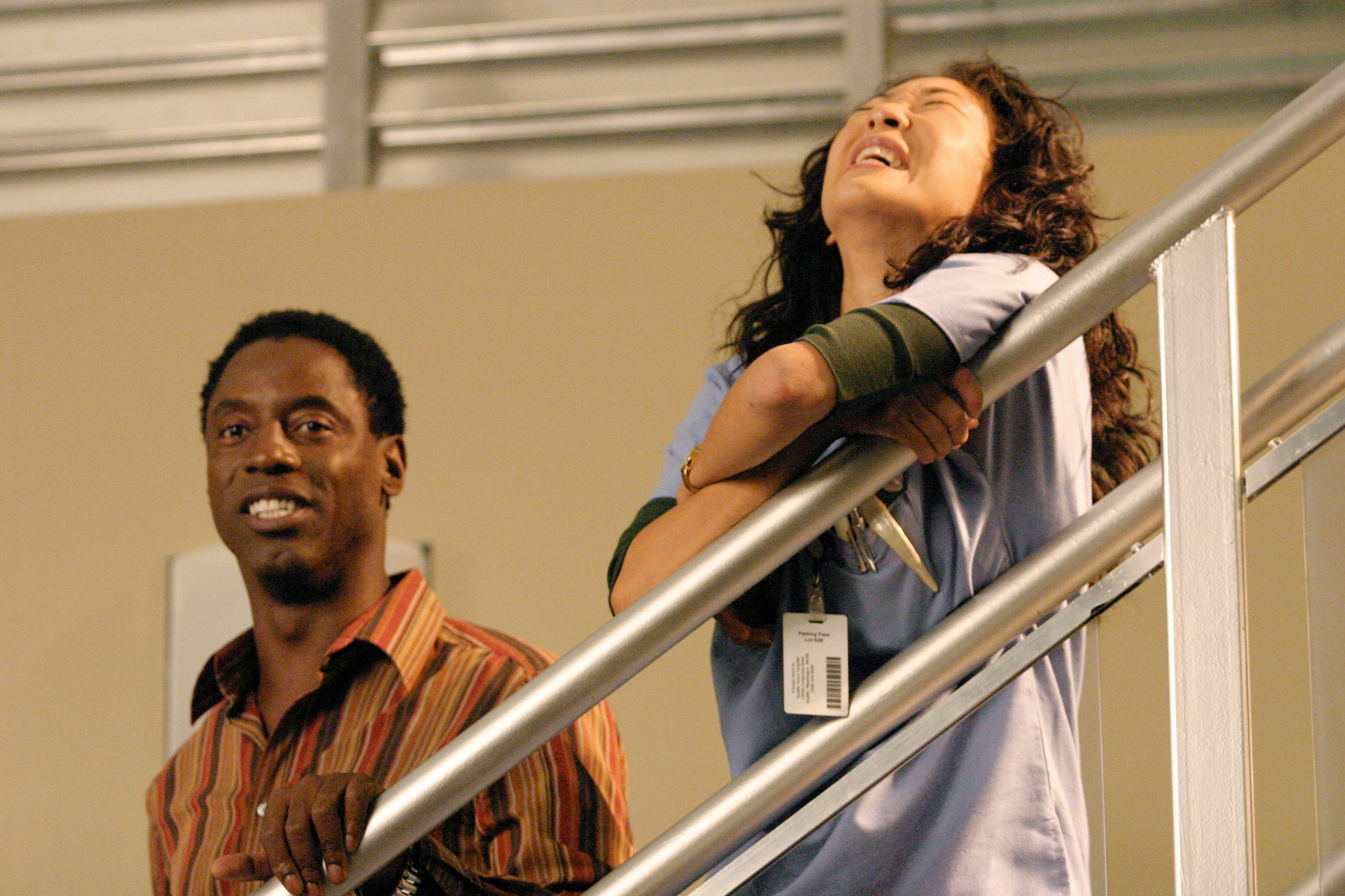 'Grey's Anatomy' stars Sandra Oh as Cristina Yang and Isaiah Washington as Preston Burke laughing during a scene.