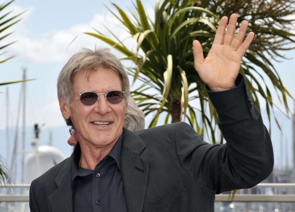Harrison Ford waves and poses