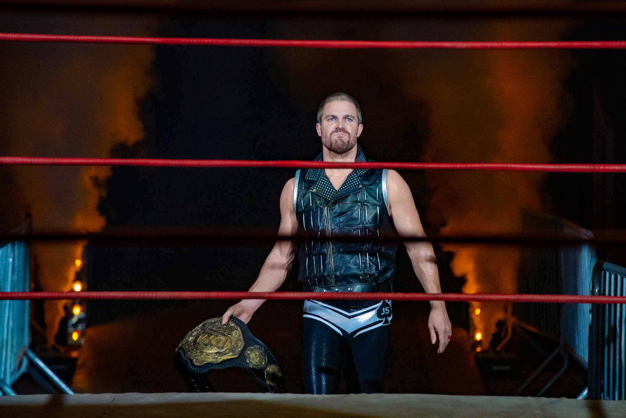 Heels: Stephen Amell carries the belt into the ring
