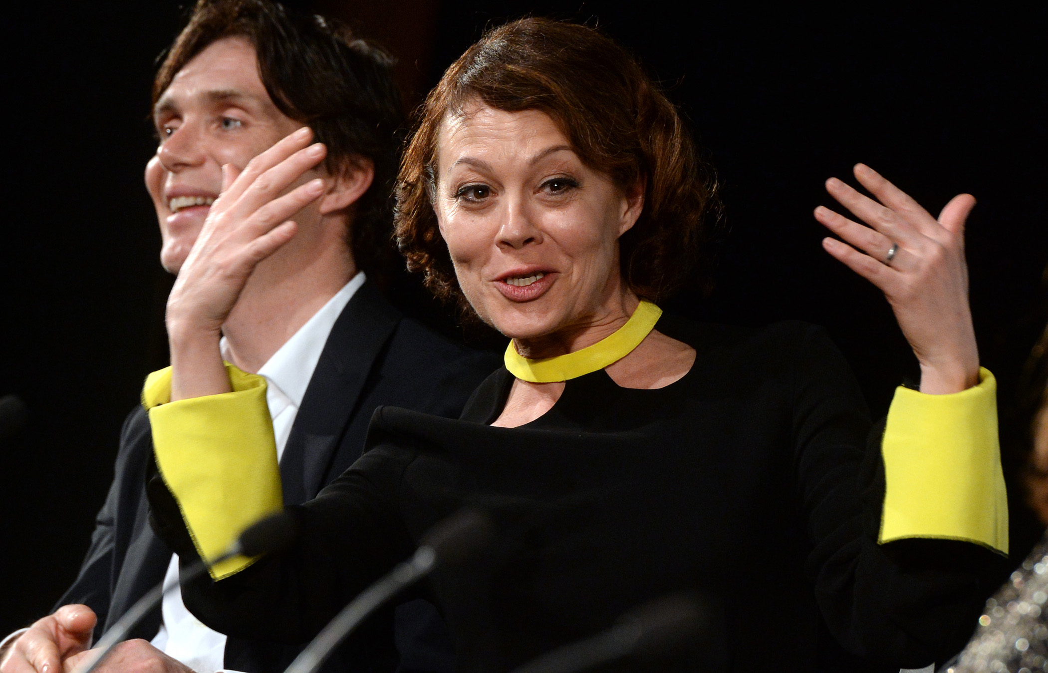 Aunt Polly Gray actor Helen McCrory talking and holding her hands up with Thomas Shelby actor Cillian Murphy in the background of the 'Peaky Blinders' premiere