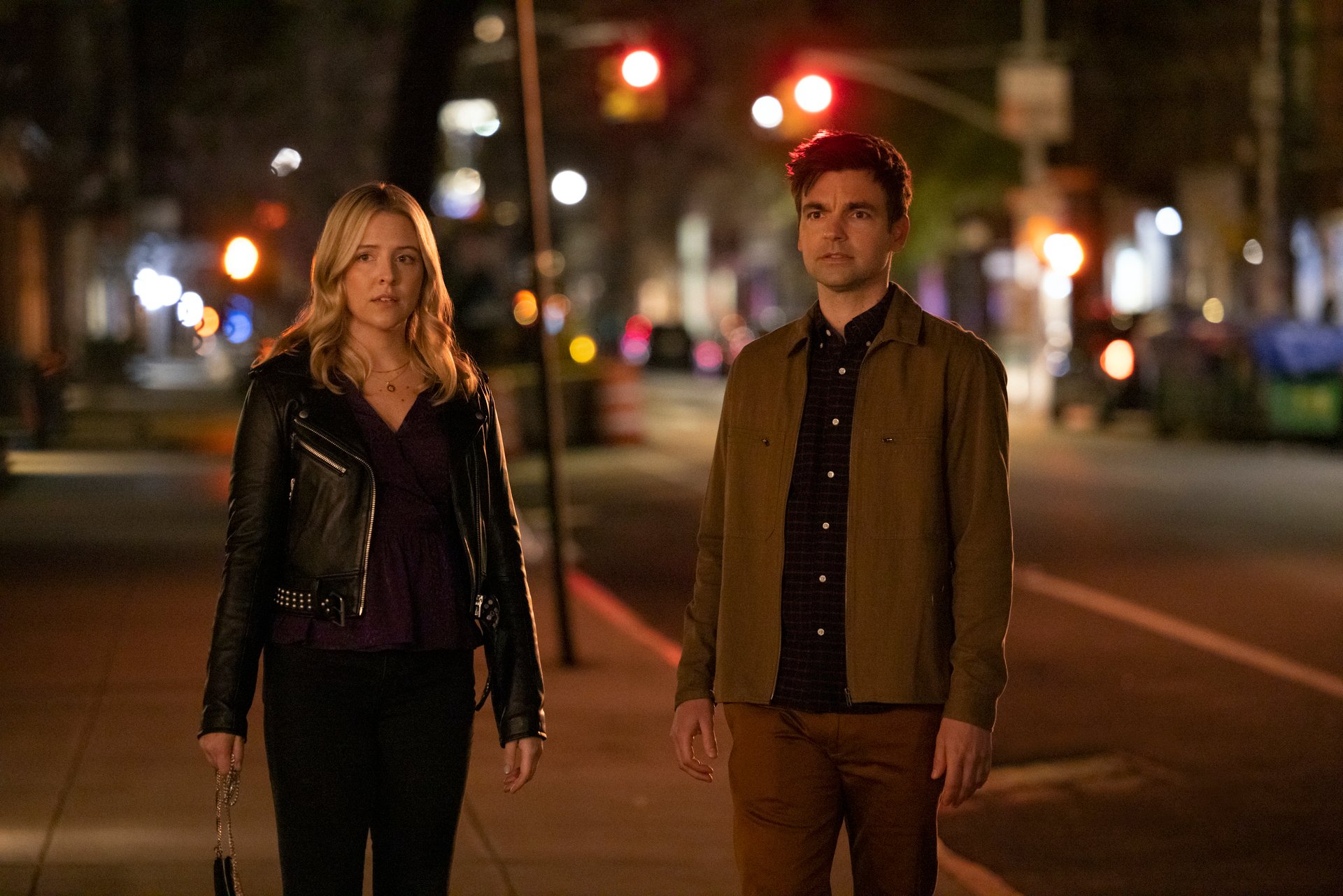 A production still of Heléne Yorke and Drew Tarver in 'The Other Two' showing them outside on a city street at night.