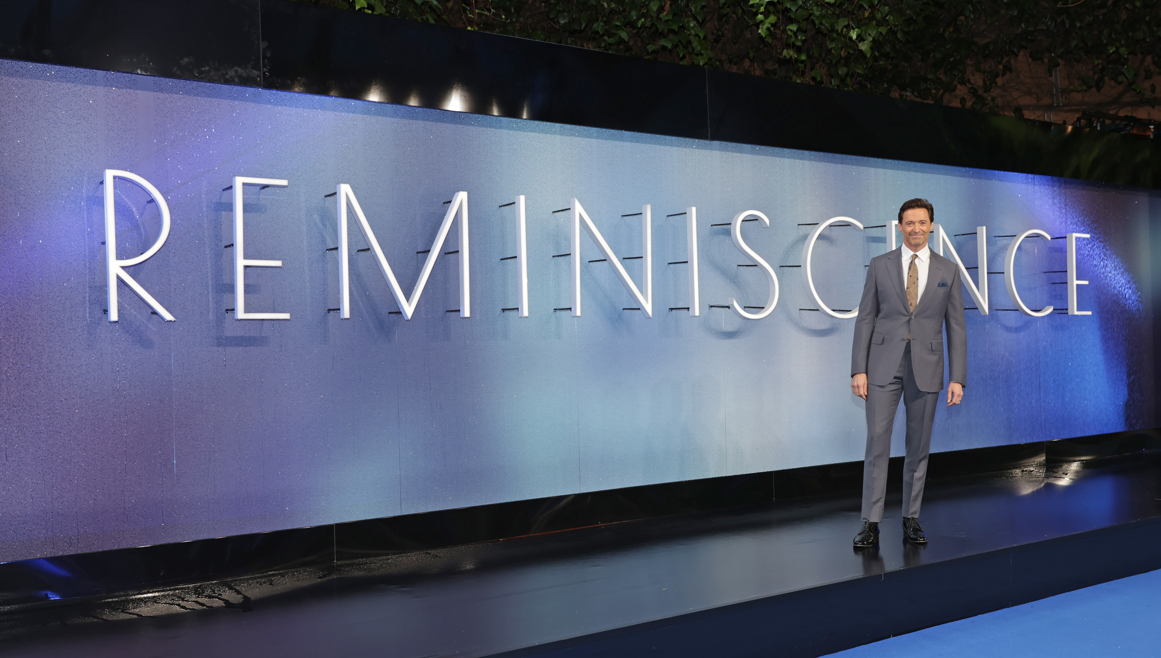 Hugh Jackman standing in front of Reminiscience sign