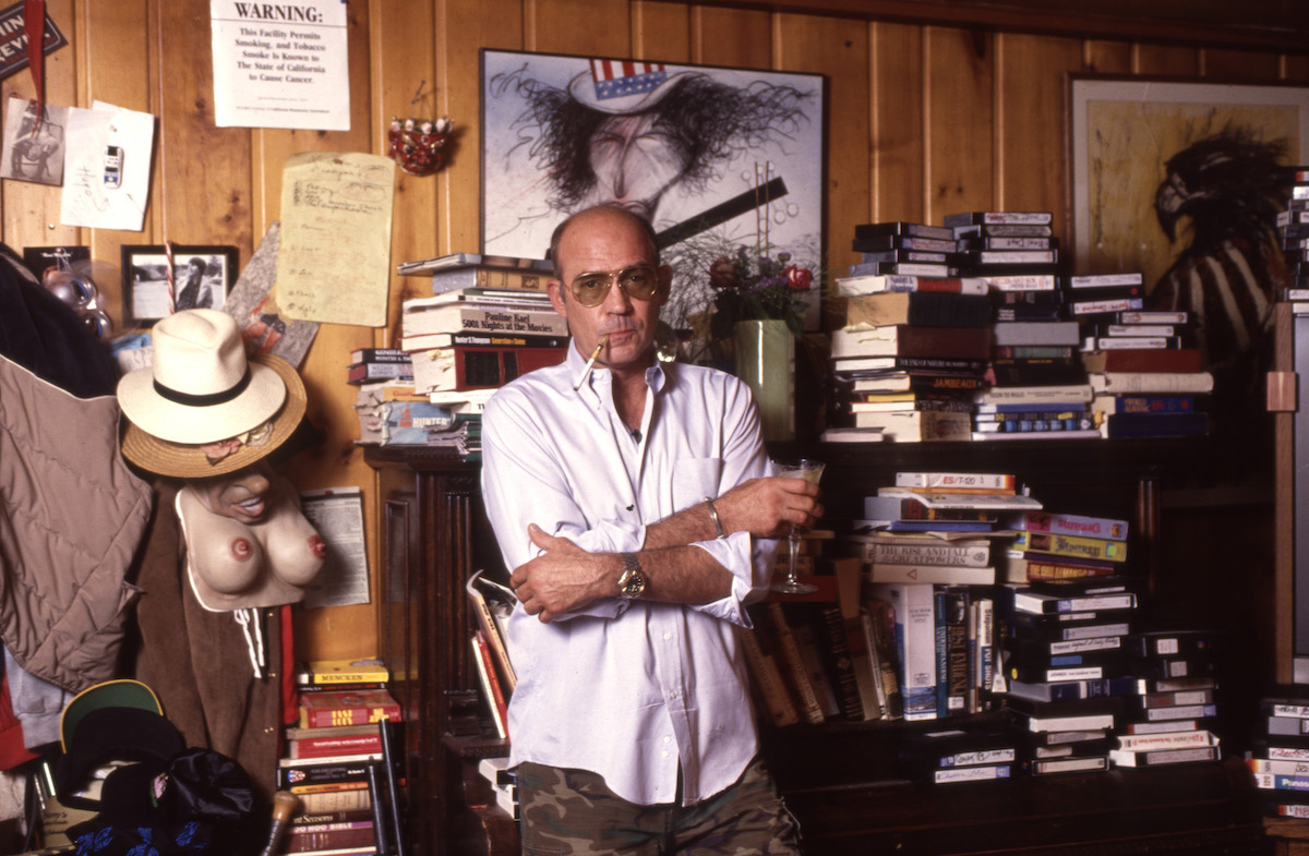 Hunter Thompson standing with books