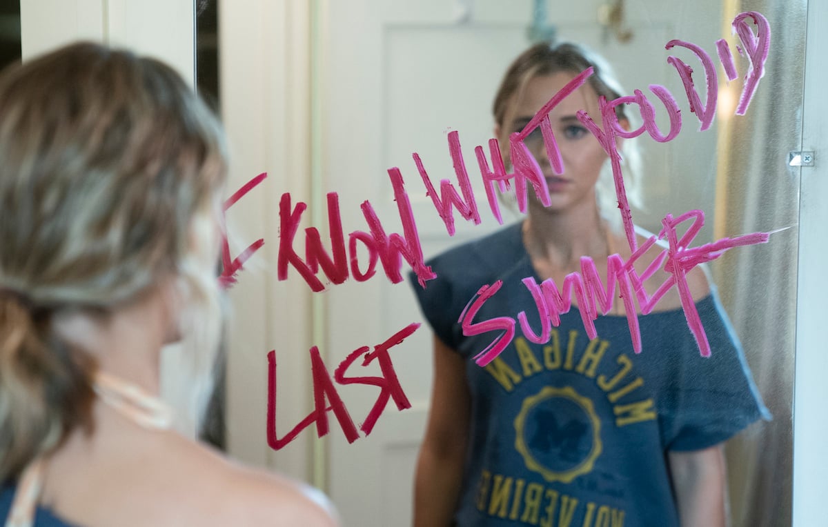Madison Iseman looking at words written on mirror in 'I Know What You Did Last Summer'