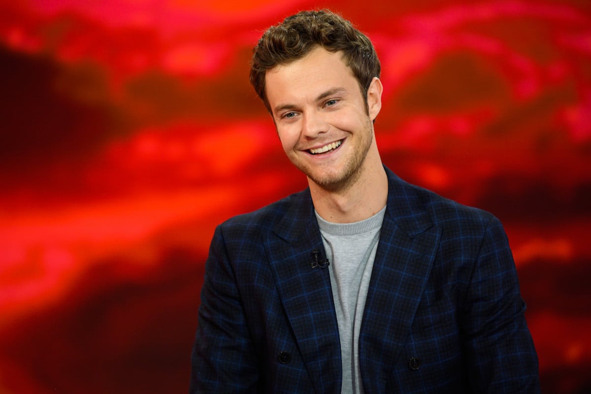 Jack Quaid smiling for media.