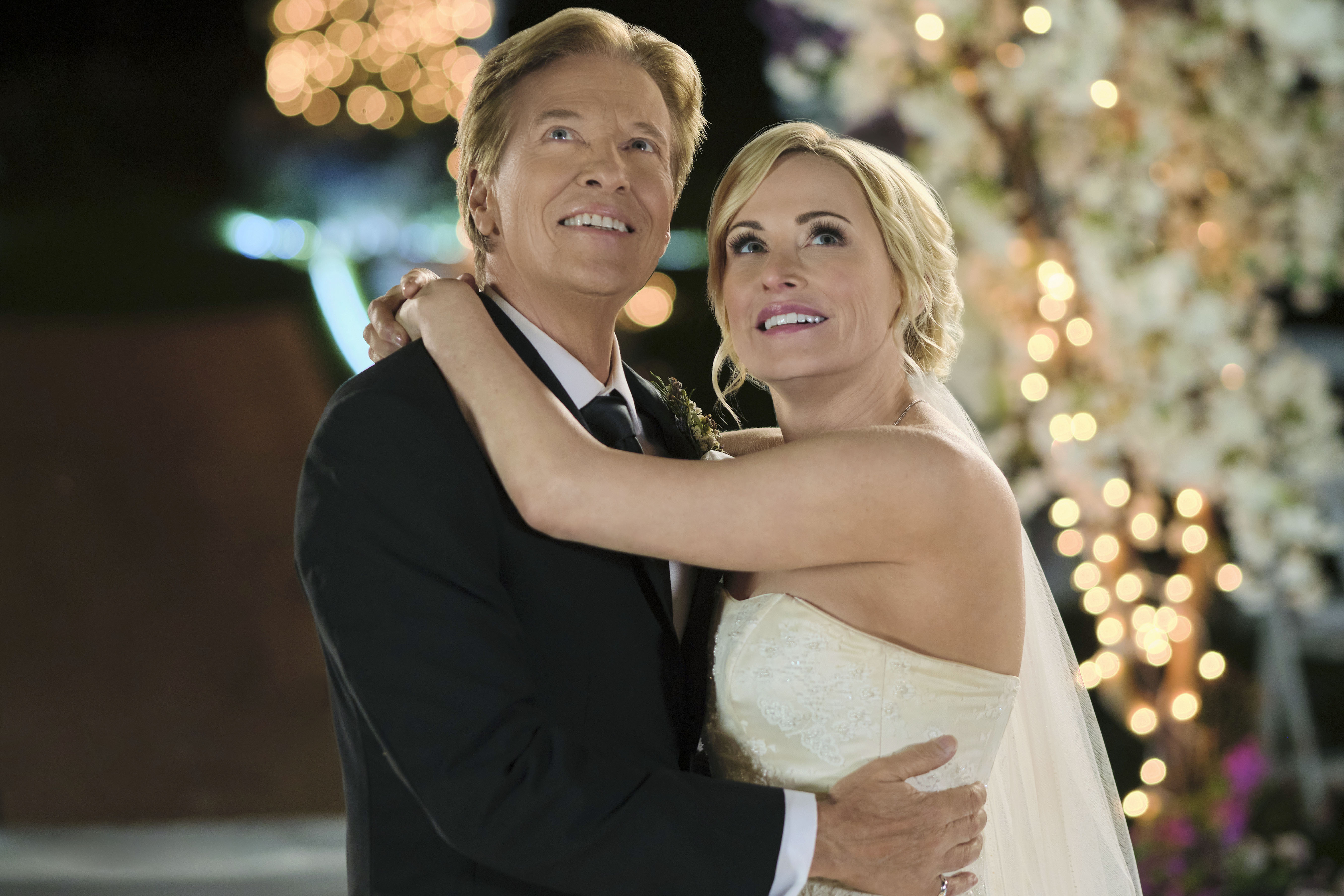 Josie Bissett, wearing a wedding dress, with her arms around Jack Wagner in 'Sealed With a Kiss: Wedding March 6'
