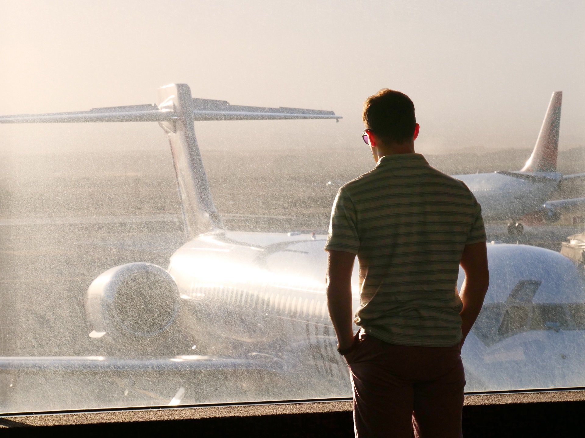 The White Lotus Season 1 Episode 6 with Jake Lacy as Shane Patton looking out at a plane